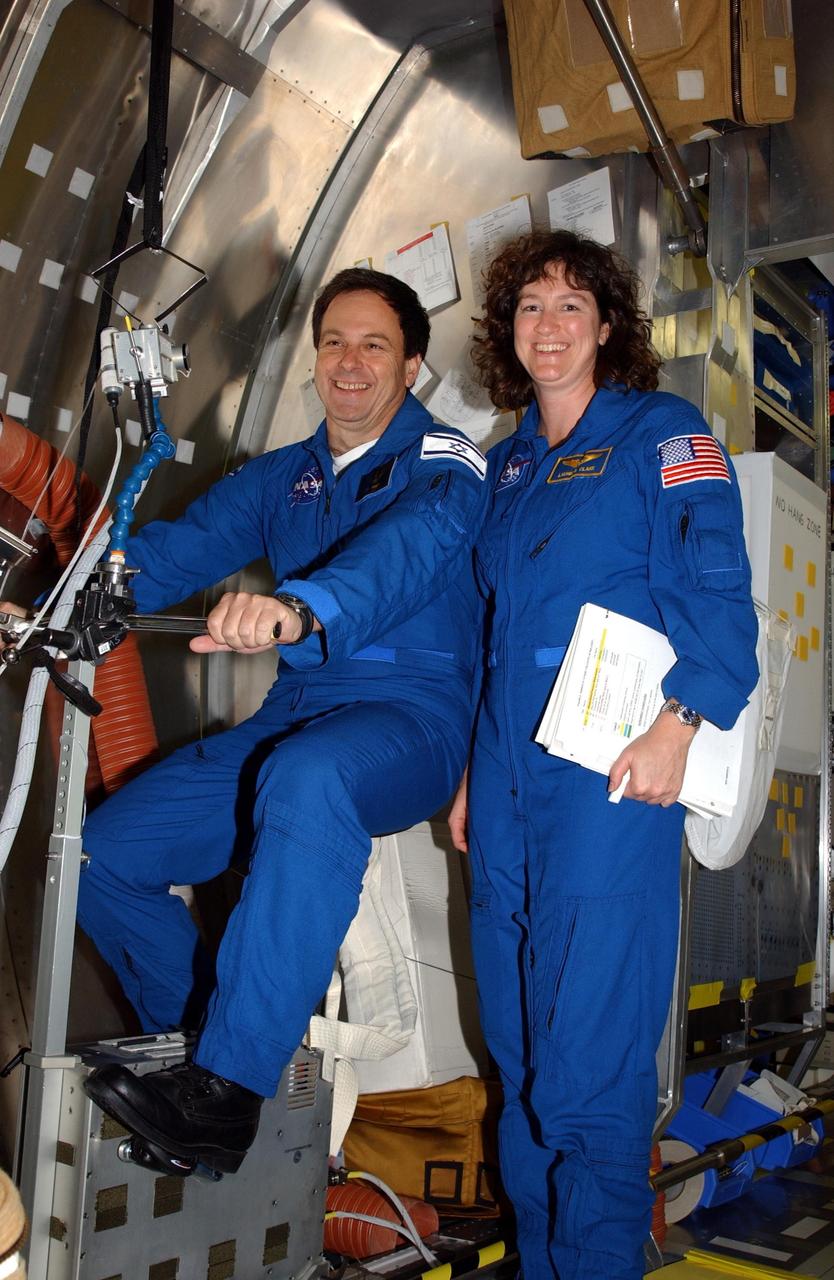 KENNEDY SPACE CENTER, FLA. -- At SPACEHAB in Cape Canaveral, Fla., STS-107 Mission Specialists Ilan Ramon of Israel and Laurel Clark check out the equipment for the mission. STS-107 is a research mission, and the primary payload is the first flight of the SHI Research Double Module (SHI/RDM). The experiments range from material sciences to life sciences (many rats). Among the experiments is a Hitchhiker carrier system, modular and expandable in accordance with payload requirements. STS-107 is scheduled to launch in June 2002