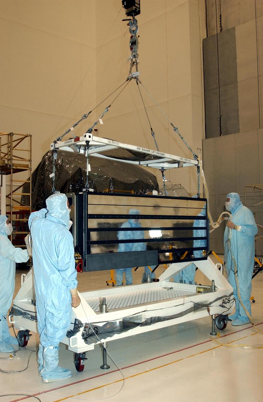 KENNEDY SPACE CENTER, FLA. --   In the Vertical Processing Facility, workers watch while an overhead crane lifts the Advanced Camera for Surveys  (ACS) off the stand.   The ACS is part of the payload on the Hubble Space Telescope Servicing Mission, STS-109.  The goal of the mission is to service the HST, replacing Solar Array 2 with Solar Array 3, replacing the Power Control Unit, removing the Faint Object Camera and installing the ACS, installing the Near Infrared Camera and Multi-Object Spectrometer (NICMOS) Cooling System, and installing New Outer Blanket Layer insulation.  Mission STS-109 is scheduled for launch no earlier than Feb. 21, 2002