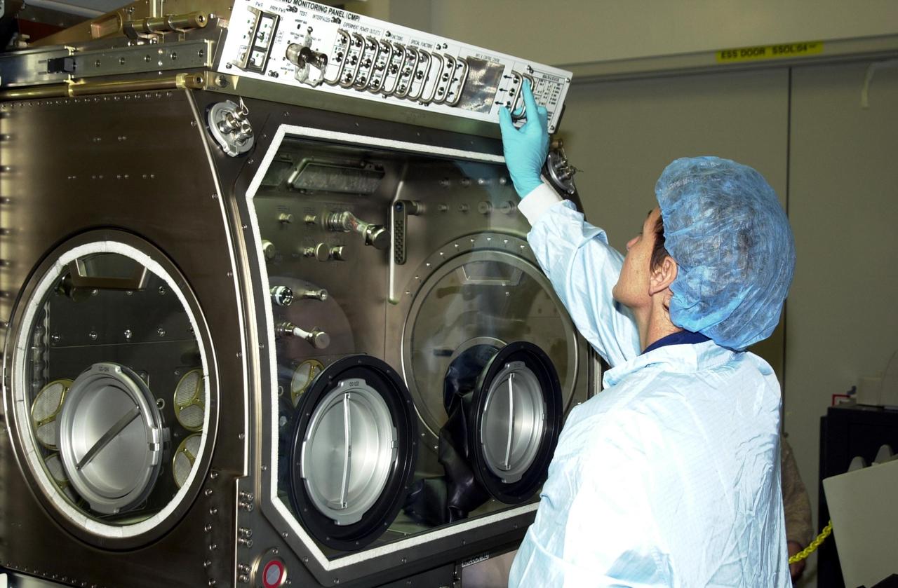 KENNEDY SPACE CENTER, FLA. -- Astronaut Peggy Whitson, a member of the Expedition 5 crew, looks over equipment in the Space Station Processing Facility. She and other crew members Commander Valeri Korzun and Sergei Treschev will be traveling to the International Space Station on mission STS-111 and will be replacing the Expedition 4 crew. Part of the payload on STS-111 will be the Mobile Base System, to be installed installed on the Mobile Transporter to complete the Canadian Mobile Servicing System, or MSS. The mechanical arm will then have the capability to "inchworm" from the U.S. Lab fixture to the MSS and travel along the Truss to work sites. STS-111 is scheduled to launch in May 2002