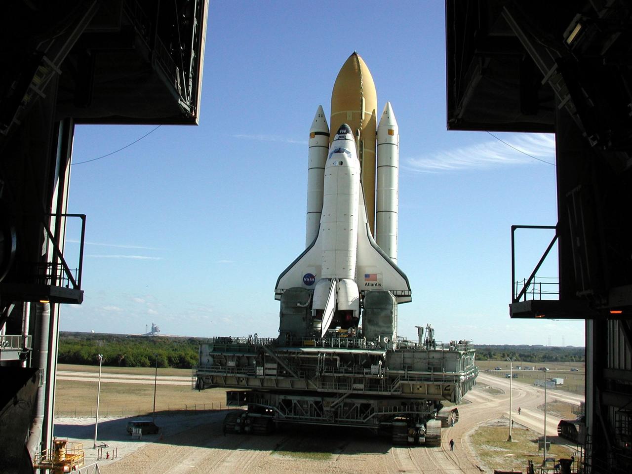 KENNEDY SPACE CENTER, Fla. -- Space Shuttle Atlantis, on its Mobile Launcher Platform, rolls out to Launch Pad 39A for the second time. An attempt to roll out on Jan. 2 incurred a failed computer processor on the first crawler transporter. The Shuttle was returned to the VAB using a secondary computer processor on the vehicle. Atlantis will fly on mission STS-98, the seventh construction flight to the International Space Station, carrying the U.S. Laboratory, named Destiny. The lab module will have five system racks already installed inside. After delivery of electronics in the lab, electrically powered attitude control for Control Moment Gyroscopes will be activated. Atlantis is scheduled for launch no earlier than Jan. 19, 2001, with a crew of five