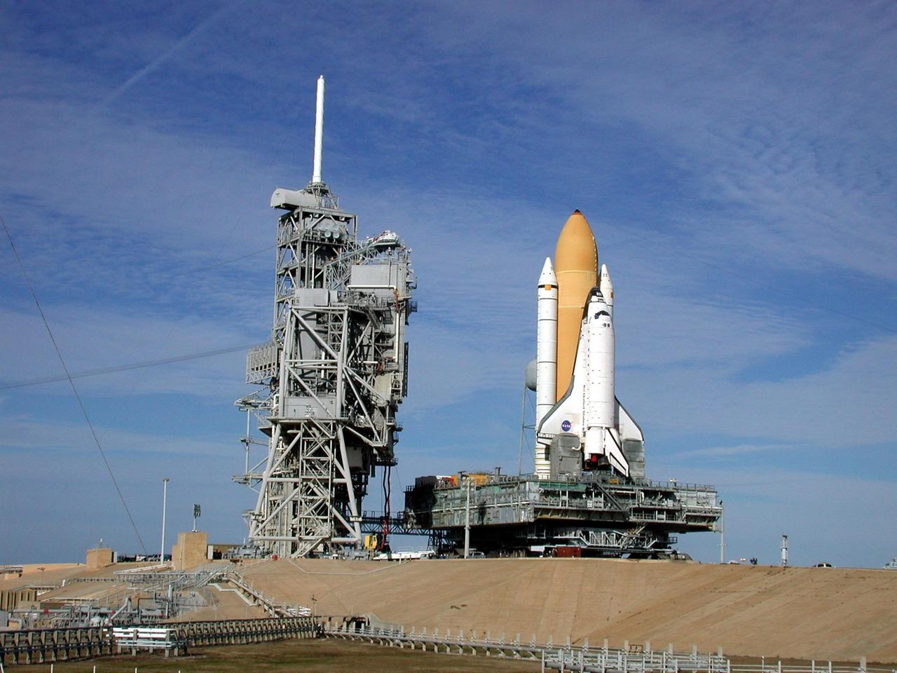 KENNEDY SPACE CENTER, Fla. -- Under wispy white morning clouds, Space Shuttle Atlantis nears the Rotating Service Structure on Launch Pad 39A. Atlantis will fly on mission STS-98, the seventh construction flight to the International Space Station, carrying the U.S. Laboratory, named Destiny. The lab will have five system racks already installed inside the module. After delivery of electronics in the lab, electrically powered attitude control for Control Moment Gyroscopes will be activated. Atlantis is scheduled for launch no earlier than Jan. 19, 2001, with a crew of five