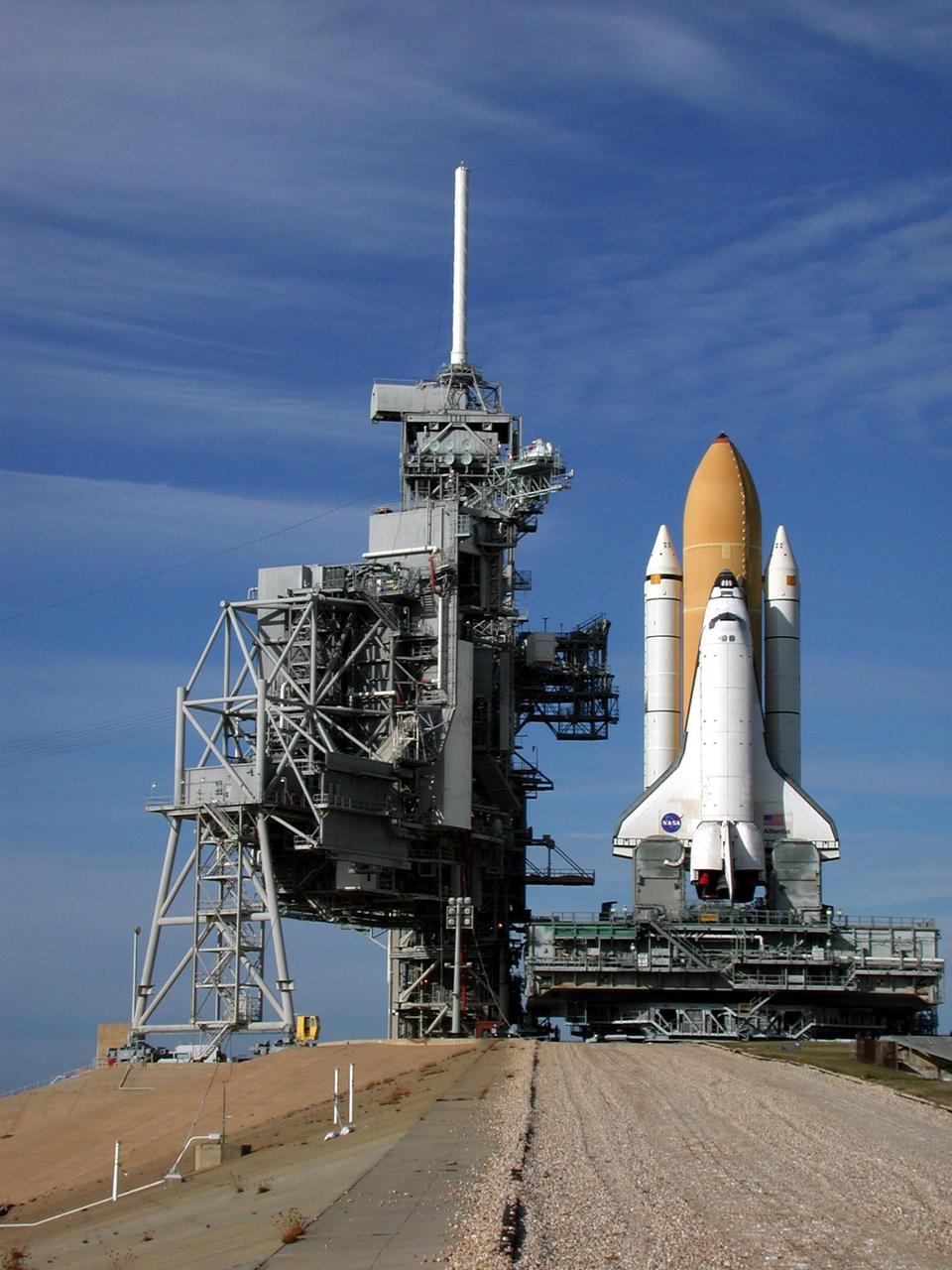 KENNEDY SPACE CENTER, Fla. -- At the top of Launch Pad 39A, Space Shuttle Atlantis closes in on the Rotating Service Structure (left). On the RSS, the payload canister can be seen half way up the structure as it is lifted to the Payload Changeout Room. Atlantis will fly on mission STS-98, the seventh construction flight to the International Space Station, carrying the U.S. Laboratory, named Destiny. The lab will have five system racks already installed inside the module. After delivery of electronics in the lab, electrically powered attitude control for Control Moment Gyroscopes will be activated. Atlantis is scheduled for launch no earlier than Jan. 19, 2001, with a crew of five