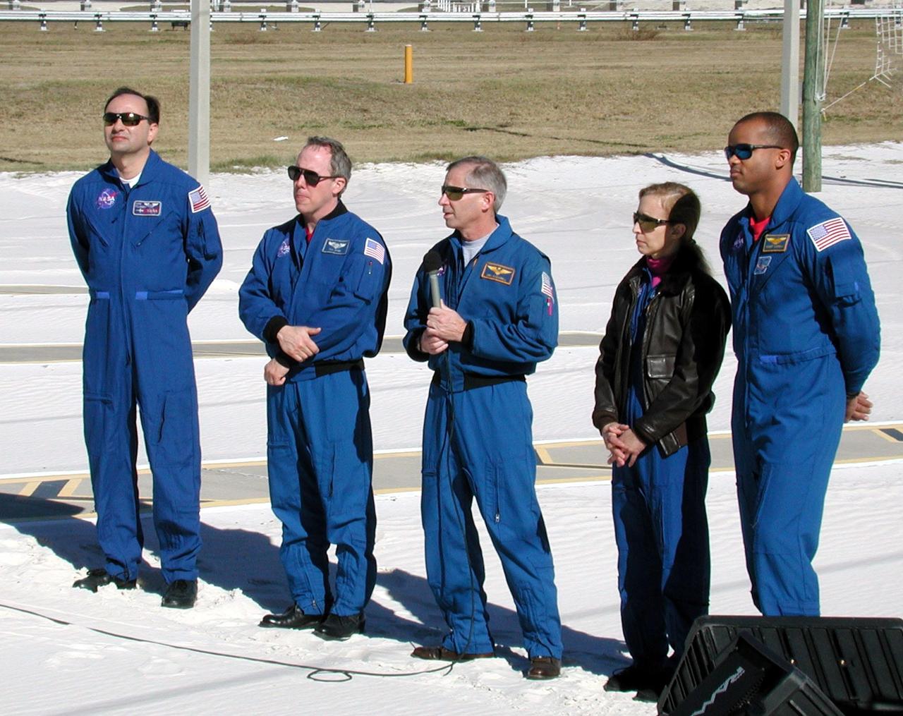 KENNEDY SPACE CENTER, Fla. --  The STS-98 crew talks to the press at a briefing at Launch Pad 39A. With the microphone is Commander Ken Cockrell, who discusses the EVAs on the mission. The other crew members are (left to right) Pilot Mark Polansky, Mission Specialist Thomas Jones, [Cockrell], and Mission Specialists Marsha Ivins and Robert Curbeam. They are at KSC to take part in Terminal Countdown Demonstration Test activities, which also include a simulated launch countdown. STS-98 is the seventh construction flight to the International Space Station, carrying as payload the U.S. Lab Destiny, a key element in the construction of the ISS. Launch of STS-98 is scheduled for Jan. 19 at 2:11 a.m