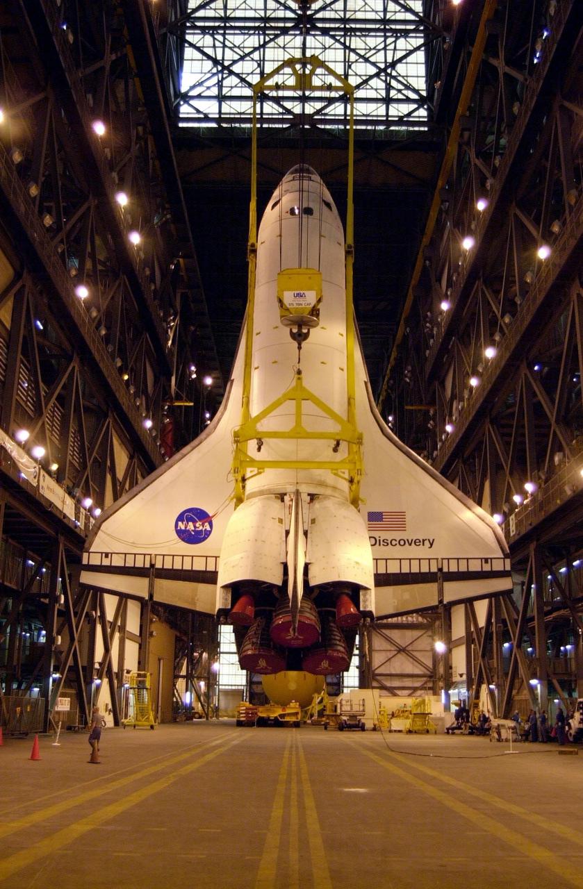The orbiter Discovery is finally vertical and hangs suspended in the transfer aisle of the Vehicle Assembly Building. It will next be moved into high bay 1 for mating with its solid rocket boosters and external tank. Discovery will be launched March 8 on mission STS-102, the eighth construction flight to the International Space Station. The Shuttle will carry the Multi-Purpose Logistics Module Leonardo, the first of three pressurized modules provided by the Italian Space Agency to carry supplies and equipment to the Space Station and back to earth