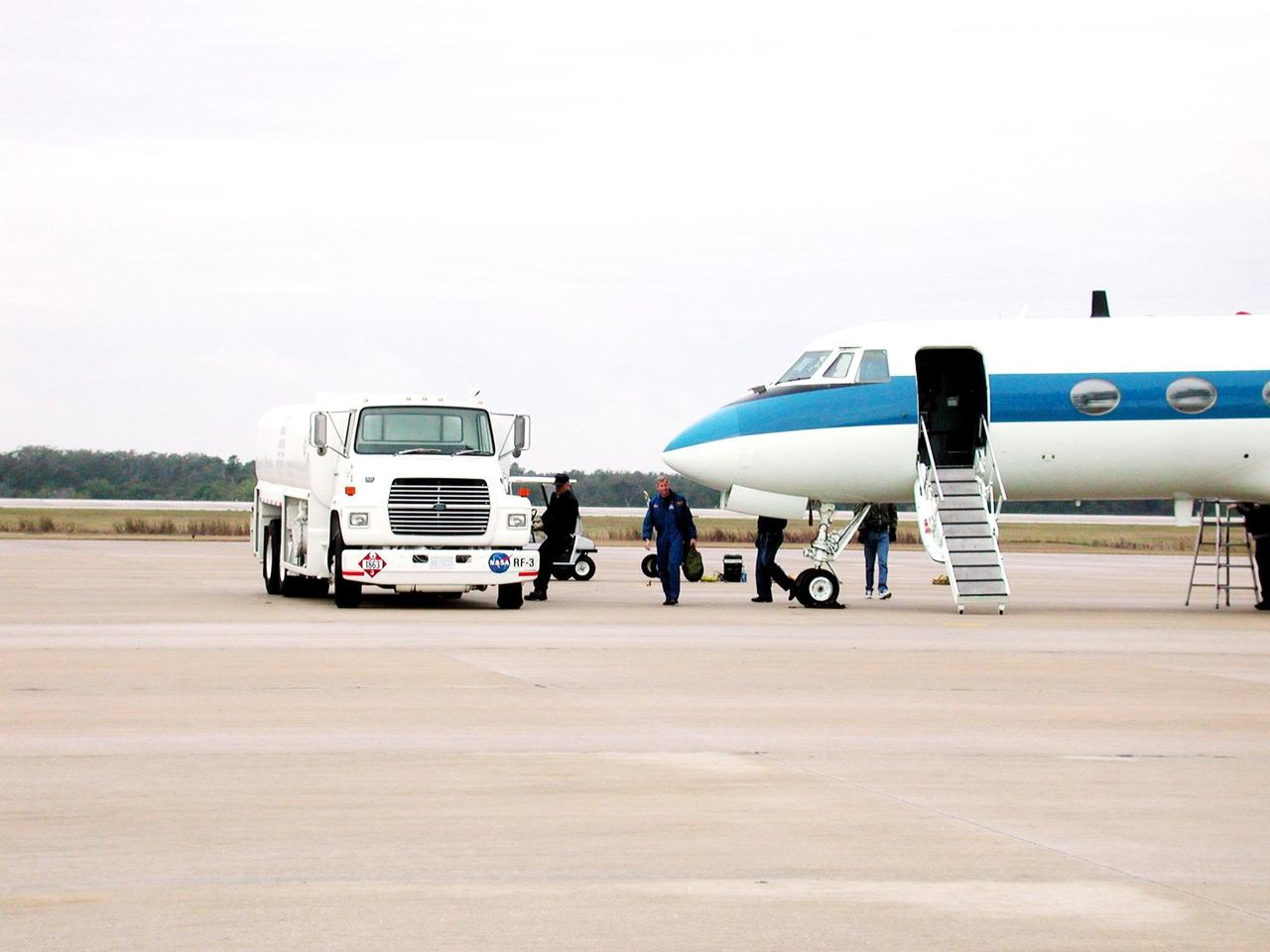 KENNEDY SPACE CENTER, FLA. -- STS-98 Commander Ken Cockrell, near the nose of the Shuttle Training Aircraft he just landed, makes his way across the parking apron of the Shuttle Landing Facility. The cockpit of the STA is outfitted like the Shuttle, which provides practice at the controls, especially for landing. The STS-98 crew recently arrived at KSC to prepare for their launch Feb. 7 to the International Space Station. The seventh construction flight to the Space Station, it will carry the U.S. Laboratory Destiny, a key module for space experiments