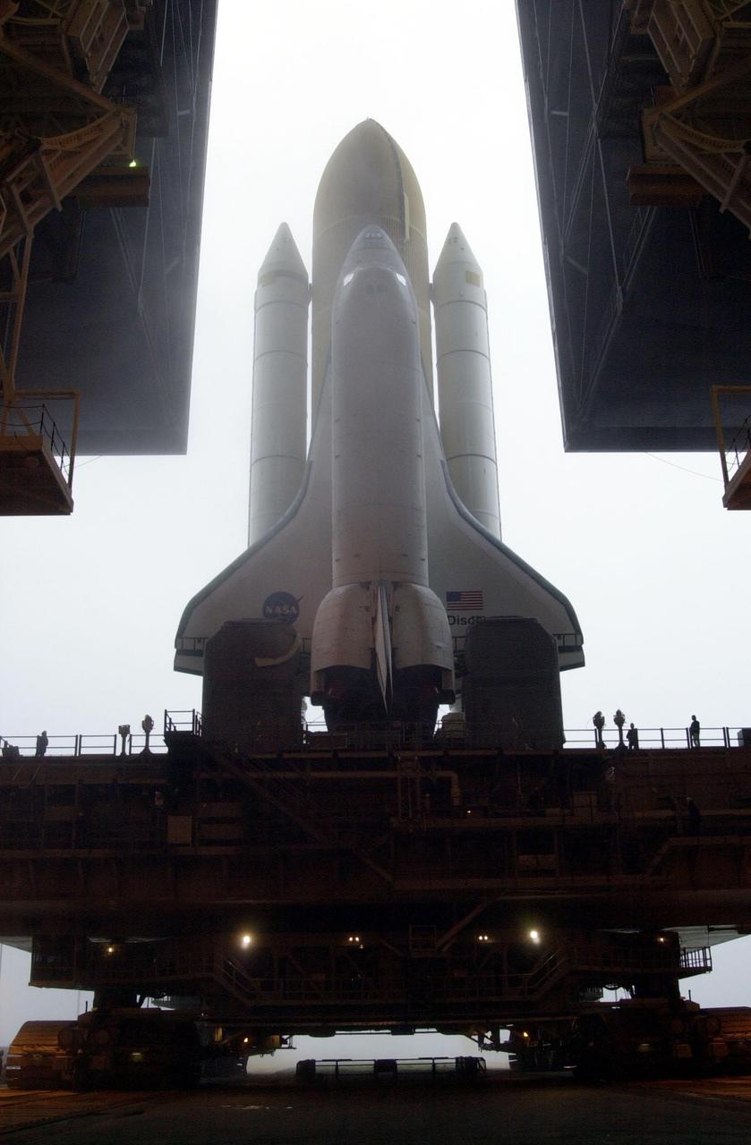 KENNEDY SPACE CENTER, Fla. -- Against a fog-filled sky, Space Shuttle Discovery starts rolling out of the Vehicle Assembly Building to Launch Pad 39B. Discovery will fly on mission STS-102 to the International Space Station. Its payload is the Multi-Purpose Logistics Module Leonardo, a “moving vans,” to carry laboratory racks filled with equipment, experiments and supplies to and from the Space Station aboard the Space Shuttle. The flight will also carry the Expedition Two crew up to the Space Station, replacing Expedition One, who will return to Earth on Discovery. Launch is scheduled for March 8 at 6:45 a.m. EST