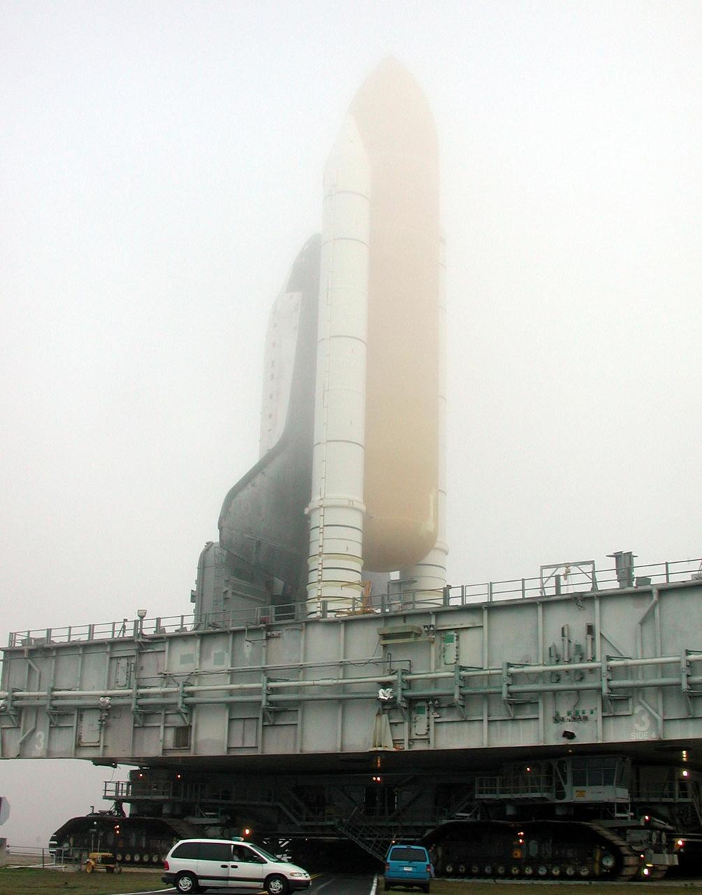 KENNEDY SPACE CENTER, Fla. -- An early morning fog at Kennedy Space Center blurs the top of Space Shuttle Discovery as it crawls from the Vehicle Assembly Building to Launch Pad 39B and mission STS-102 to the International Space Station. Its payload is the Multi-Purpose Logistics Module Leonardo, a “moving van,” to carry laboratory racks filled with equipment, experiments and supplies to and from the Space Station aboard the Space Shuttle. The flight will also carry the Expedition Two crew up to the Space Station, replacing Expedition One, who will return to Earth on Discovery Launch is scheduled for March 8 at 6:45 a.m. EST