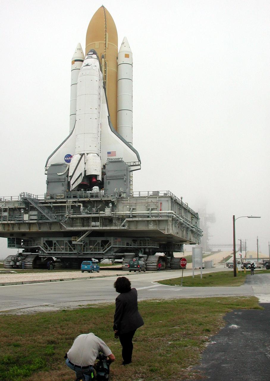 KENNEDY SPACE CENTER, Fla. -- This closeup shows Space Shuttle Discovery as it travels to Launch Pad 39B. Underneath Discovery is the Mobile Launcher Platform, a two-story movable launch base. Part of the MPLM is the tail service mast, seen here at the bottom of the wind and next to the Shuttle’s main engines. The tail service mast is 31 feet high, 15 feet long and 9 feet wide. A second TSM is on the other side. They support the fluid, gas and electrical requirements of the orbiter’s liquid oxygen and liquid hydrogen aft T-0 umbilicals. Discovery will be flying on mission STS-102 to the International Space Station. Its payload is the Multi-Purpose Logistics Module Leonardo, a “moving van,” to carry laboratory racks filled with equipment, experiments and supplies to and from the Space Station aboard the Space Shuttle. The flight will also carry the Expedition Two crew up to the Space Station, replacing Expedition One, who will return to Earth on Discovery. Launch is scheduled for March 8 at 6:45 a.m. EST