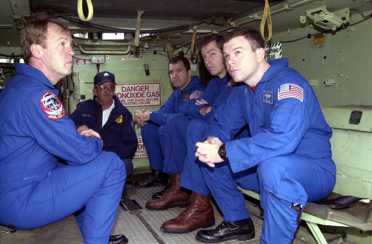 The STS-102 crew wait for instructions about the M-113 armored carrier they are seated in. At left is Mission Specialist Andy Thomas. On the right side are (left to right) Mission Specialist Paul Richards, Commander James Wetherbee and Pilot James Kelly. In the event of an emergency at the pad prior to launch, the carrier could be used to transport the crew to a nearby bunker or farther. The STS-102 crew is at KSC to take part in Terminal Countdown Demonstration Test activities, which also include a simulated launch countdown. STS-102 is the eighth construction flight to the International Space Station, carrying as payload the Multi-Purpose Logistics Module Leonardo. Launch on mission STS-102 is scheduled for March 8