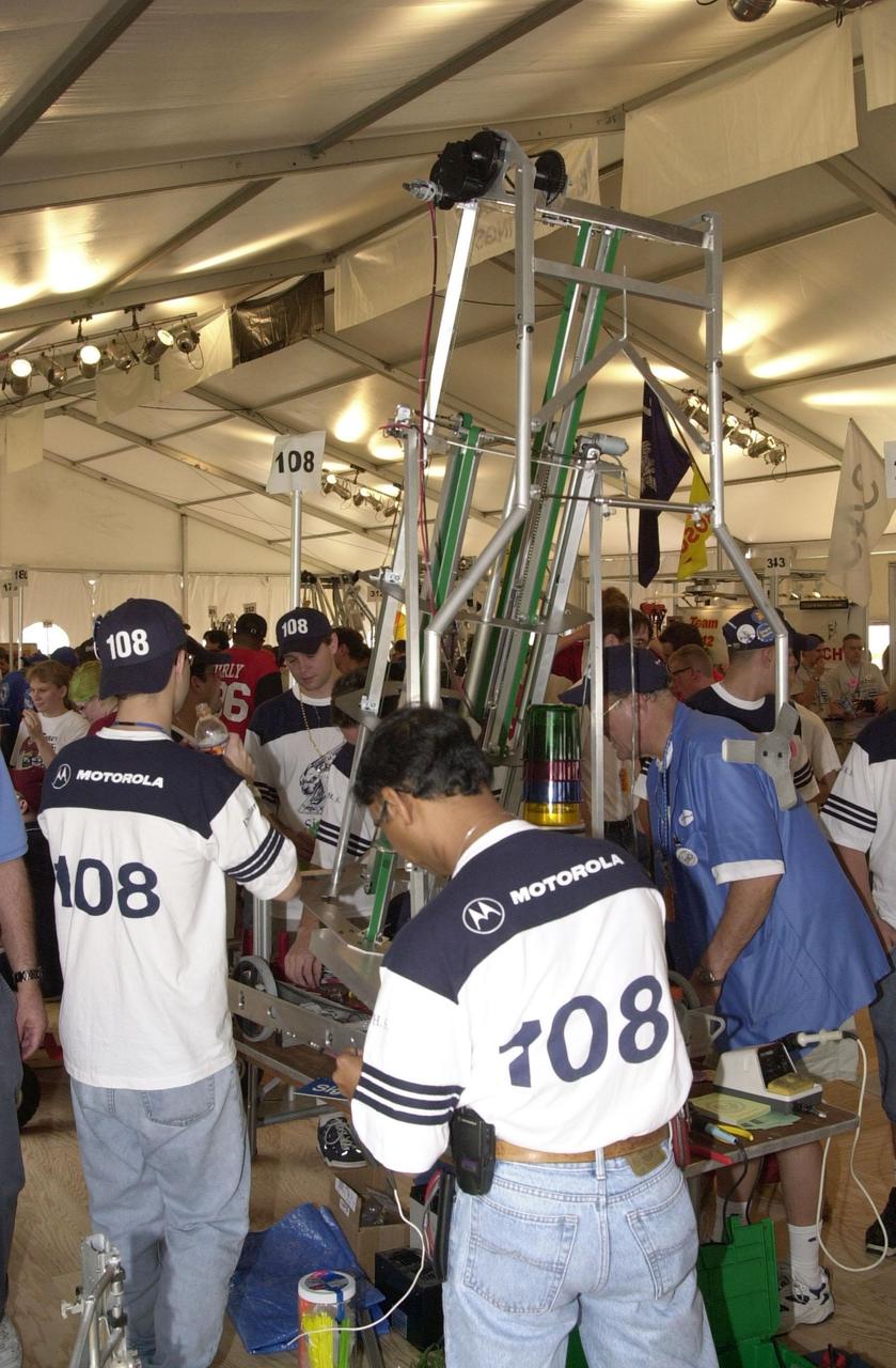 Students from Plantation, Fla., and their mentors prepare their team robot to compete in the  NASA/KSC FIRST Southeastern Regional event. FIRST (For Inspiration and Recognition of Science and Technology) events are held nationwide, pitting the student-built robots against each other and the clock on a playing field.  Many teams are sponsored by corporations, such as Motorola seen on these students’ shirts, and academic institutions. There are 27 teams throughout the State of Florida who are competing.  KSC, which sponsors nine teams, has held the regional event for two years.