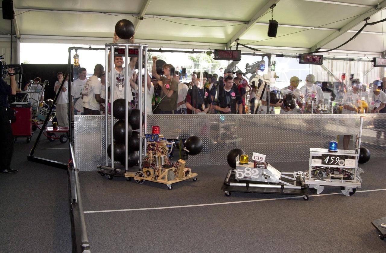 Student teams direct their robots on the playing field during the NASA/KSC FIRST Southeastern Regional event held March 1-3, 2001. Robot number 582 is by the Viking Electros, W.M. Raines High School, Jacksonville, Fla. Number 459 is by Eastside High School, Gainesville, Fla. FIRST (For Inspiration and Recognition of Science and Technology) events are held nationwide, pitting robots against each other and the clock on a playing field. Many teams are sponsored by corporations and academic institutions. There are 27 teams throughout the State of Florida who are competing. KSC, which sponsors nine teams, has held the regional event for two years