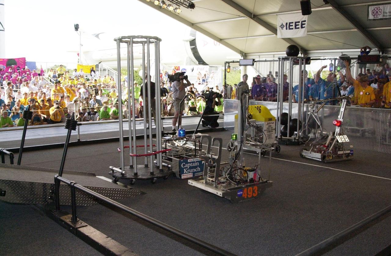 Robots, controlled by student teams, vie for points on the playing field during the NASA/KSC FIRST Southeastern Regional event held March 1-3, 2001. Three are KSC joint-sponsored teams: numbers 493, 386 and 168. FIRST (For Inspiration and Recognition of Science and Technology) events are held nationwide, pitting robots against each other and the clock on a playing field. Many teams are sponsored by corporations and academic institutions. There are 27 teams throughout the State of Florida who are competing. KSC, which sponsors nine teams, has held the regional event for two years