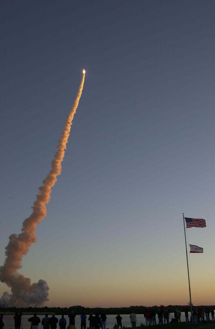 KENNEDY SPACE CENTER, Fla. -- Space Shuttle Discovery outshines a rising sun as it blasts off on mission STS-102, the eighth construction flight to the International Space Station. The lower smoke plumes appear red from the dawn’s rays. Liftoff occurred on time at 6:42:09 EST