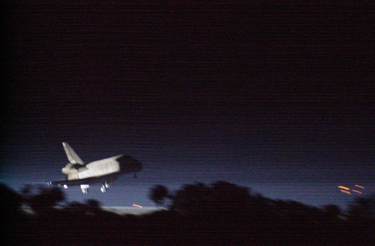 KENNEDY SPACE CENTER, Fla. -- Getting a break in the weather, Space Shuttle Discovery prepares to land at the KSC Shuttle Landing Facility March 21, on runway 15. Main gear touchdown occurred at 2:31:42 a.m. EST, nose wheel touchdown at 2:31:54 a.m., and wheel stop at 2:33:06 a.m. The landing on orbit 201 concluded mission STS-102, the eighth flight to the International Space Station, carrying the first Multi-Purpose Logistics Module Leonardo, to the ISS and Expedition Two, a replacement crew for the Station. The 12-day, 19-hour, 51-minute mission returned both the Leonardo and the first resident crew of the ISS, Expedition One, to KSC. Discovery logged 5.3 million miles on this mission. The landing marked the 54th at KSC in the history of the program, and the 12th night landing at KSC