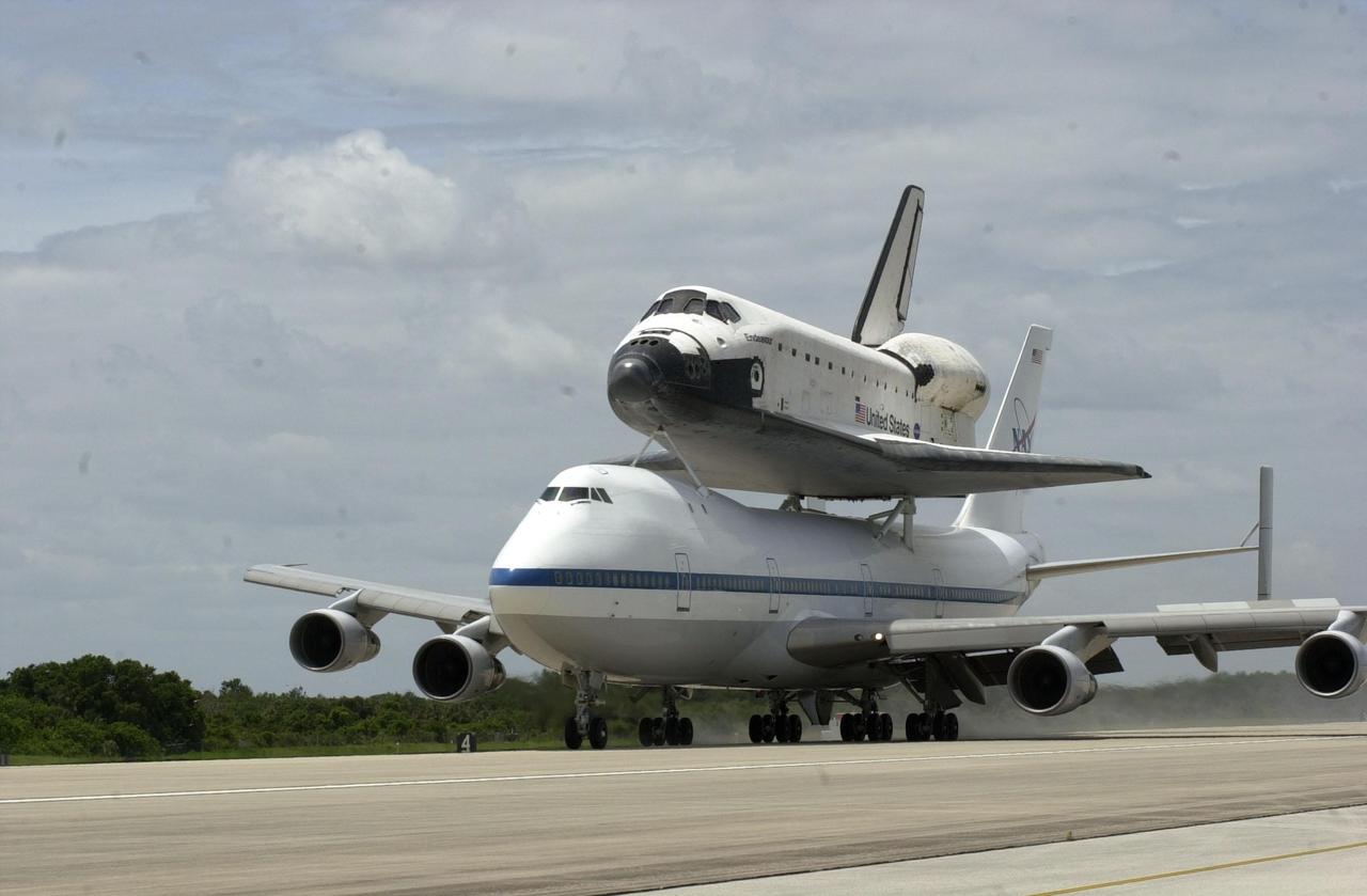 KENNEDY SPACE CENTER, FLA. -- Orbiter Endeavour returns to KSC’s Shuttle Landing Facility mounted atop NASA’s Shuttle Carrier Aircraft. The duo completed a two-day transcontinental ferry flight from Edwards Air Force Base, Calif. Endeavour landed at Edwards AFB after a 12-day mission, STS-100, to the International Space Station. Endeavour will be towed to the Orbiter Processing Facility bay 1 where it will begin processing for mission STS-108