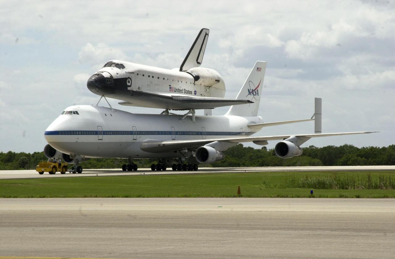 KENNEDY SPACE CENTER, FLA. -- Orbiter Endeavour, mounted atop NASA’s Shuttle Carrier Aircraft, is getting ready to be towed to the mate/demate device after its landing at the Shuttle Landing Facility. The duo completed a two-day transcontinental ferry flight from Edwards Air Force Base, Calif. Endeavour landed at Edwards AFB after a 12-day mission, STS-100, to the International Space Station. Endeavour will be demated from the SCA and towed to the Orbiter Processing Facility bay 1 where it will begin processing for mission STS-108