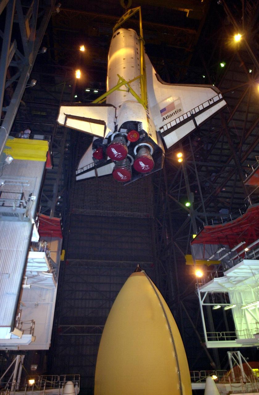 KENNEDY SPACE CENTER, FLA. -- In Vehicle Assembly Building high bay 1, the orbiter Atlantis is being lowered into position for mating to its external tank/solid rocket booster stack.; Space Shuttle Atlantis is scheduled to launch on mission STS-104 in early July