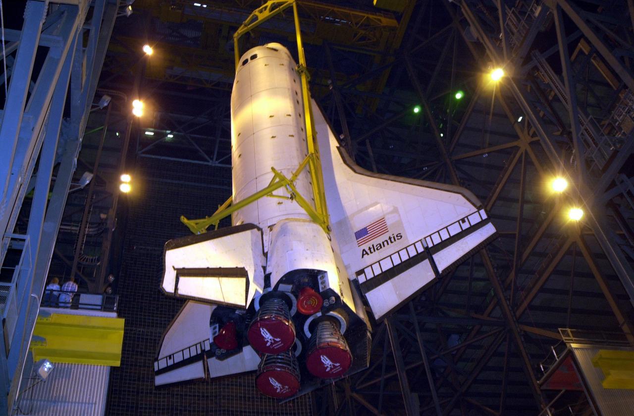 KENNEDY SPACE CENTER, FLA. -- In Vehicle Assembly Building high bay 1, the orbiter Atlantis is being lowered into position for mating to its external tank/solid rocket booster stack.; Space Shuttle Atlantis is scheduled to launch on mission STS-104 in early July