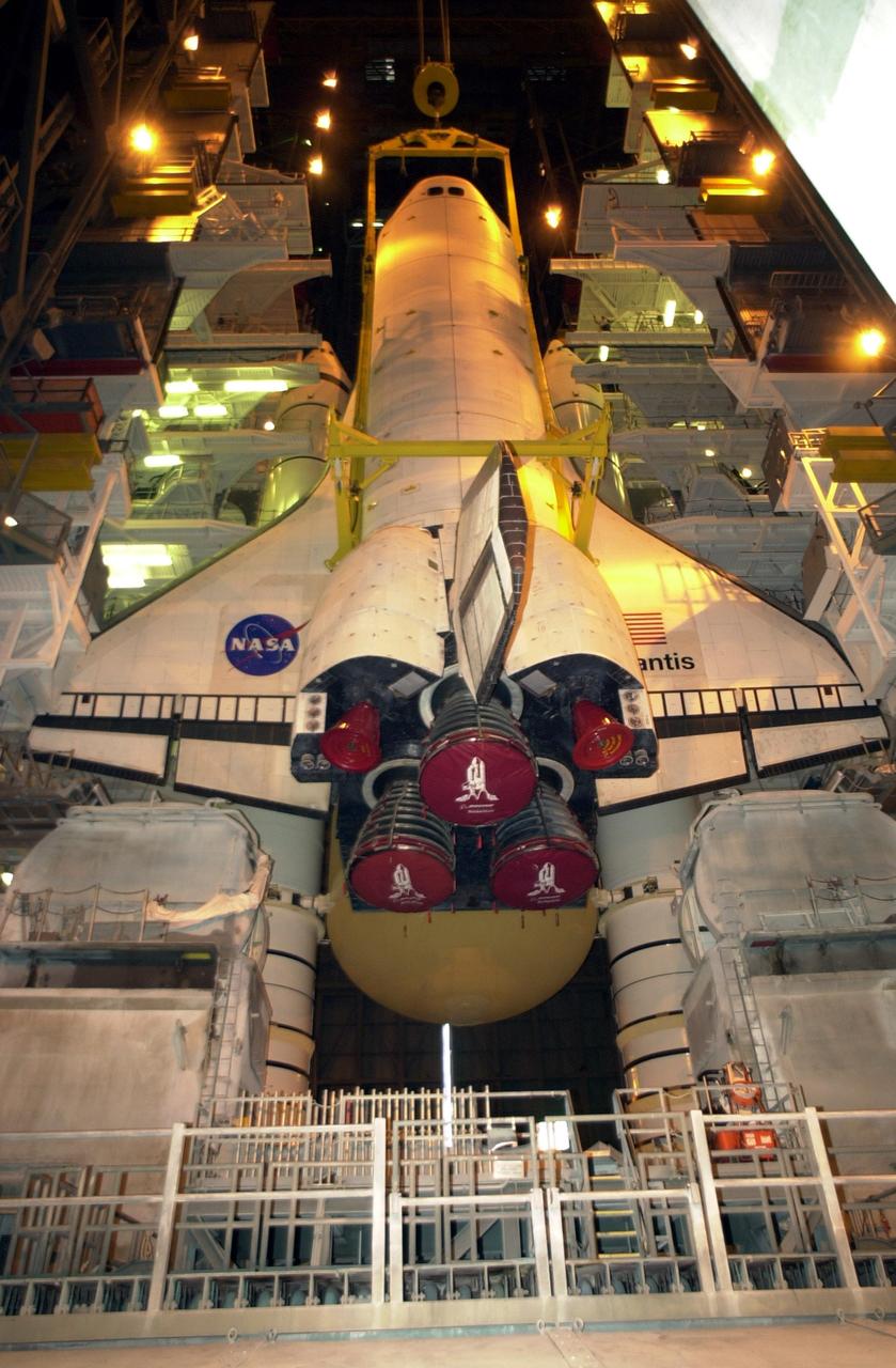 KENNEDY SPACE CENTER, FLA. -- In Vehicle Assembly Building high bay 1, the orbiter Atlantis is being lowered into position for mating to its external tank/solid rocket booster stack.; Space Shuttle Atlantis is scheduled to launch on mission STS-104 in early July