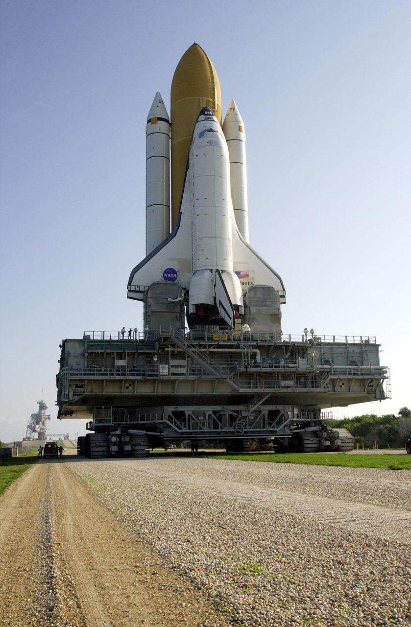 KENNEDY SPACE CENTER, Fla. -- Sitting atop the mobile launcher platform, Space Shuttle Atlantis wends its way to Launch Pad 39B. The Shuttle is targeted for launch no earlier than July 12 on mission STS-104, the 10th flight to the International Space Station. The payload on the 11-day mission is the Joint Airlock Module, which will allow astronauts and cosmonauts in residence on the Station to perform future spacewalks without the presence of a Space Shuttle. The module, which comprises a crew lock and an equipment lock, will be connected to the starboard (right) side of Node 1 Unity. Atlantis will also carry oxygen and nitrogen storage tanks, vital to operation of the Joint Airlock, on a Spacelab Logistics Double Pallet in the payload bay. The tanks, to be installed on the perimeter of the Joint Module during the mission’s spacewalks, will support future spacewalk operations and experiments plus augment the resupply system for the Station’s Service Module