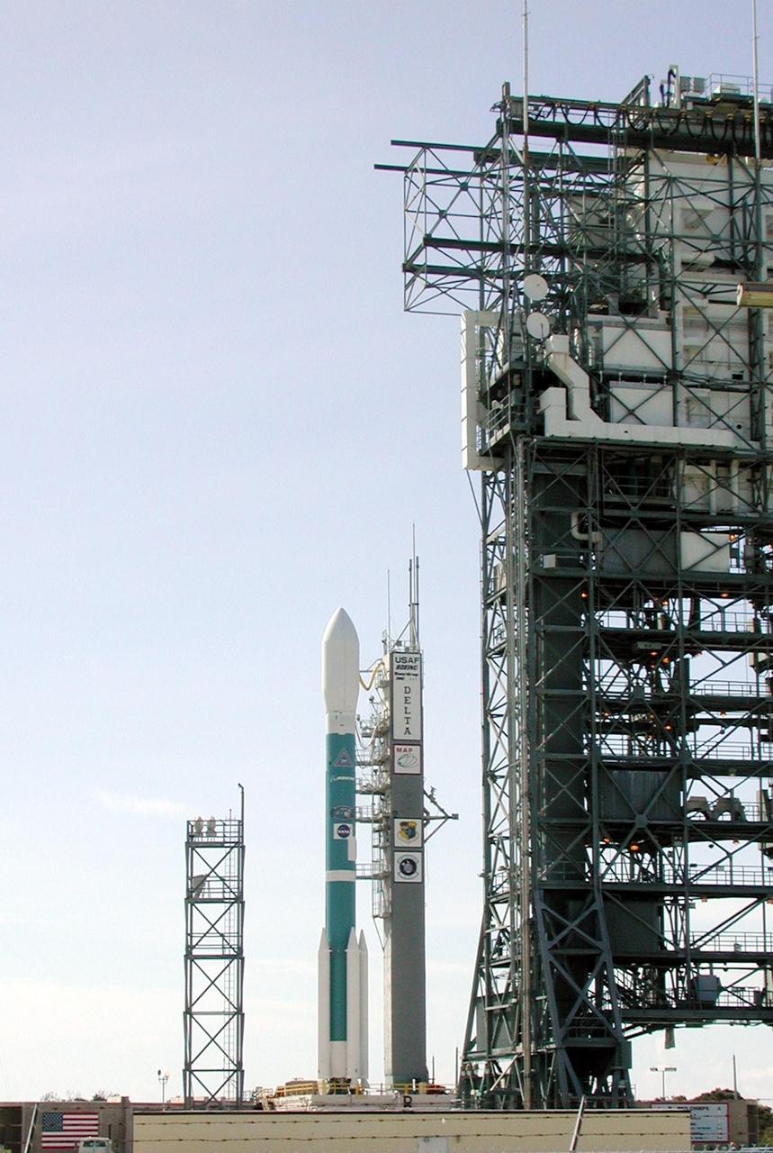 KENNEDY SPACE CENTER, Fla. -- The Boeing Delta II rocket is poised for flight on Launch Complex 17-A, Cape Canaveral Air Force Station, after rollback of the Mobile Service Tower (right). Topping the rocket is the payload, the Microwave Anisotropy Probe (MAP) spacecraft. Launch is scheduled at 3:46 p.m. EDT June 30. The launch will place MAP into a lunar-assisted trajectory to the Sun-Earth for a 27-month mission. The probe will measure small fluctuations in the temperature of the cosmic microwave background radiation to an accuracy of one millionth of a degree. These measurements should reveal the size, matter content, age, geometry and fate of the universe. They will also reveal the primordial structure that grew to form galaxies and will test ideas about the origins of these primordial structures. The MAP instrument will be continuously shaded from the Sun, Earth, and Moon by the spacecraft. The probe is a product of Goddard Space Flight Center in partnership with Princeton University