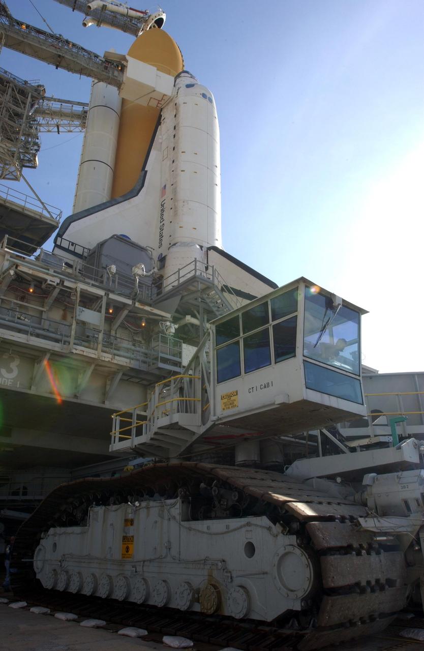 KENNEDY SPACE CENTER, Fla. -- The crawler-transporter (bottom) rolls out from under Space Shuttle Discovery and the mobile launcher platform on Launch Pad 39A. The crawler-transporter earlier moved the Shuttle and MLP from the Vehicle Assembly Building on a six-hour journey of 3.4 miles. Discovery is scheduled to launch in early August on mission STS-105. Photo by Scott Andrews using a Nikon D1X camera