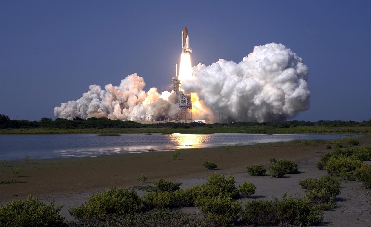 KENNEDY SPACE CENTER, Fla. -- Space Shuttle Discovery hurtles into the heavens to rendezvous with the International Space Station on mission STS-105. Liftoff occurred on time at 5:10:14 p.m. EDT on this second launch attempt. Launch countdown activities for the 12-day mission were called off Aug. 9 during the T-9 minute hold due to the high potential for lightning, a thick cloud cover and the potential for showers. Besides the Shuttle crew of four, Discovery carries the Expedition Three crew who will replace Expedition Two on the International Space Station. The mission includes the third flight of an Italian-built Multi-Purpose Logistics Module delivering additional scientific racks, equipment and supplies for the Space Station, and two spacewalks. Part of the payload is the Early Ammonia Servicer (EAS) tank, which will be attached to the Station during the spacewalks. The EAS contains spare ammonia for the Station’s cooling system. The three-member Expedition Two crew will be returning to Earth aboard Discovery after a five-month stay on the Station. [Photo by Scott Andrews; Nikon D1X camera