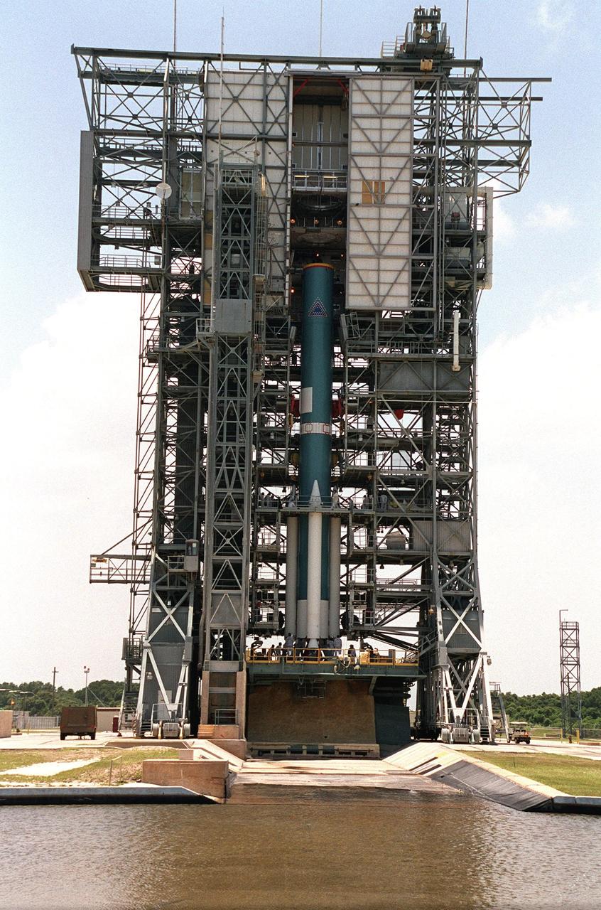 KENNEDY SPACE CENTER, Fla. -- -- Technicians work on the bottom of the solid rocket boosters and Delta II rocket that will launch the Genesis spacecraft. Genesis will capture samples of the ions and elements in the solar wind and return them to Earth for scientists to use to determine the exact composition of the Sun and the solar system’s origin. NASA’s Genesis project is managed by the Jet Propulsion Laboratory in Pasadena, Calif. Lockheed Martin Astronautics built the Genesis spacecraft for NASA in Denver, Colo. Launch of Genesis aboard a Boeing Delta II rocket is scheduled for July 30 at 12:36 p.m. EDT