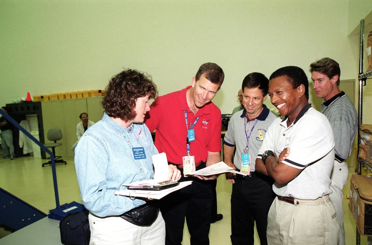 KENNEDY SPACE CENTER, Fla. -- At SPACEHAB, Cape Canaveral, Fla., the STS-107 crew takes part in Crew Equipment Interface Test (CEIT) activities. From left are Mission Specialist Laurel Blair Salton Clark, Commander Rick Douglas Husband, Payload Specialist Ilan Ramon, of Israel, and Payload Commander Michael P. Anderson. A trainer is at far right. As a research mission, STS-107 will carry the Spacehab Double Module in its first research flight into space and a broad collection of experiments ranging from material science to life science. The CEIT activities enable the crew to perform certain flight operations, operate experiments in a flight-like environment, evaluate stowage locations and obtain additional exposure to specific experiment operations. Other STS-107 crew members are Pilot William C. McCool and Mission Specialists Kalpana Chawla and David M. Brown. STS-107 is scheduled for launch May 23, 2002