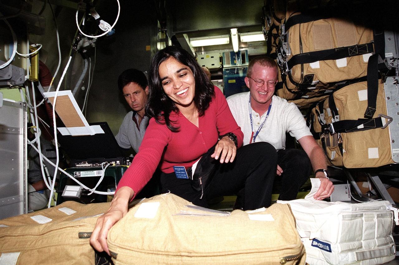 KENNEDY SPACE CENTER, Fla. -- At SPACEHAB, Cape Canaveral, Fla., STS-107 Mission Specialist Kalpana Chawla checks out items stored in the Spacehab module. Behind her, left, is Payload Specialist Ilan Ramon, of Israel, looking over a piece of equipment. At right is a trainer. The crew is taking part in Crew Equipment Interface Test (CEIT) activities at SPACEHAB, Port Canaveral, Fla. As a research mission, STS-107 will carry the Spacehab Double Module in its first research flight into space and a broad collection of experiments ranging from material science to life science. The CEIT activities enable the crew to perform certain flight operations, operate experiments in a flight-like environment, evaluate stowage locations and obtain additional exposure to specific experiment operations. Other STS-107 crew members are Commander Rick Douglas Husband, Pilot William C. McCool; Payload Commander Michael P. Anderson; and Mission Specialists Laurel Blair Salton Clark and David M. Brown. STS-107 is scheduled for launch May 23, 2002