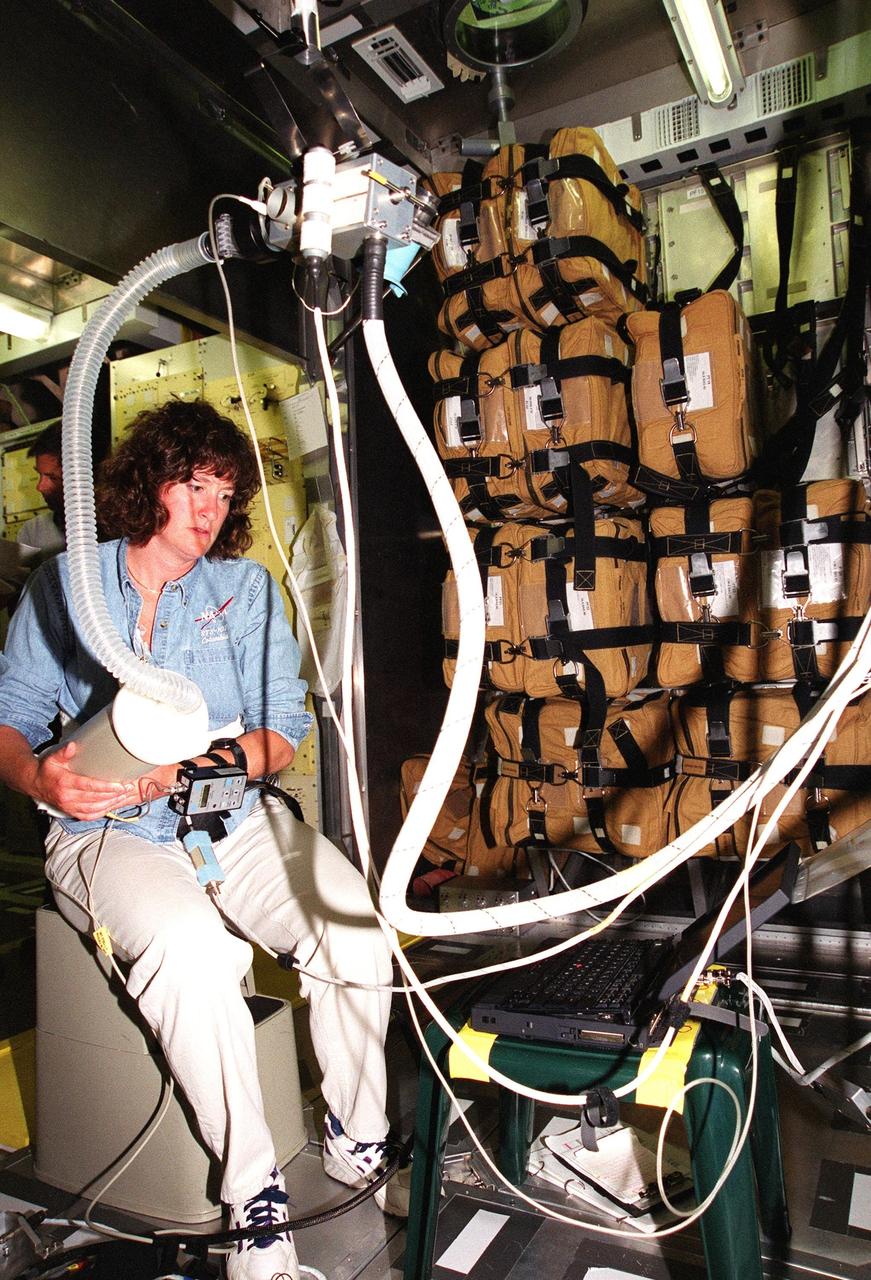 KENNEDY SPACE CENTER, Fla. -- At SPACEHAB, Cape Canaveral, Fla., STS-107 Mission Specialist Laurel Blair Salton Clark manipulates a piece of equipment. She and other crew members are at SPACEHAB, Port Canaveral, Fla., for Crew Equipment Interface Test (CEIT) activities that enable the crew to perform certain flight operations, operate experiments in a flight-like environment, evaluate stowage locations and obtain additional exposure to specific experiment operations. As a research mission, STS-107 will carry the Spacehab Double Module in its first research flight into space and a broad collection of experiments ranging from material science to life science. Other STS-107 crew members are Commander Rick Douglas Husband, Pilot William C. McCool; Payload Commander Michael P. Anderson; and Mission Specialists Kalpana Chawla, David M. Brown and Ilan Ramon, of Israel. STS-107 is scheduled for launch May 23, 2002