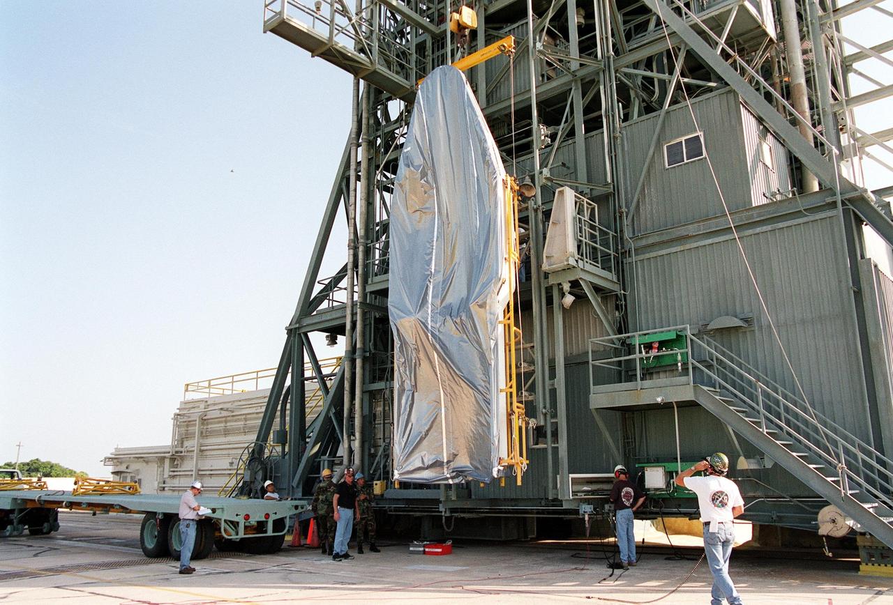 KENNEDY SPACE CENTER, Fla. -- At Launch Complex 17-A, Cape Canaveral Air Force Station, the second part of the fairing for the Genesis spacecraft is lifted up the gantry. The fairing will encapsulate the spacecraft to protect it during launch aboard a Delta II rocket. Genesis will be on a journey to capture samples of the ions and elements in the solar wind and return them to Earth for scientists to use to determine the exact composition of the Sun and the solar system’s origin. NASA’s Genesis project in managed by the Jet Propulsion Laboratory in Pasadena, Calif. Lockheed Martin Astronautics built the Genesis spacecraft for NASA in Denver, Colo. The launch is scheduled for July 30 at 12:36 p.m. EDT