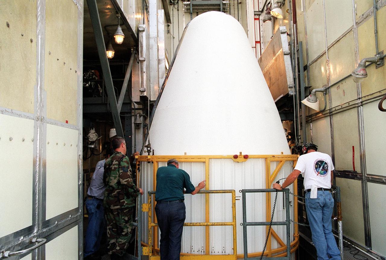 KENNEDY SPACE CENTER, Fla. -- At Launch Complex 17-A, Cape Canaveral Air Force Station, the second part of the fairing for the Genesis spacecraft arrives at the top of the gantry. The fairing will encapsulate the spacecraft to protect it during launch aboard a Delta II rocket. Genesis will be on a journey to capture samples of the ions and elements in the solar wind and return them to Earth for scientists to use to determine the exact composition of the Sun and the solar system’s origin. NASA’s Genesis project in managed by the Jet Propulsion Laboratory in Pasadena, Calif. Lockheed Martin Astronautics built the Genesis spacecraft for NASA in Denver, Colo. The launch is scheduled for July 30 at 12:36 p.m. EDT