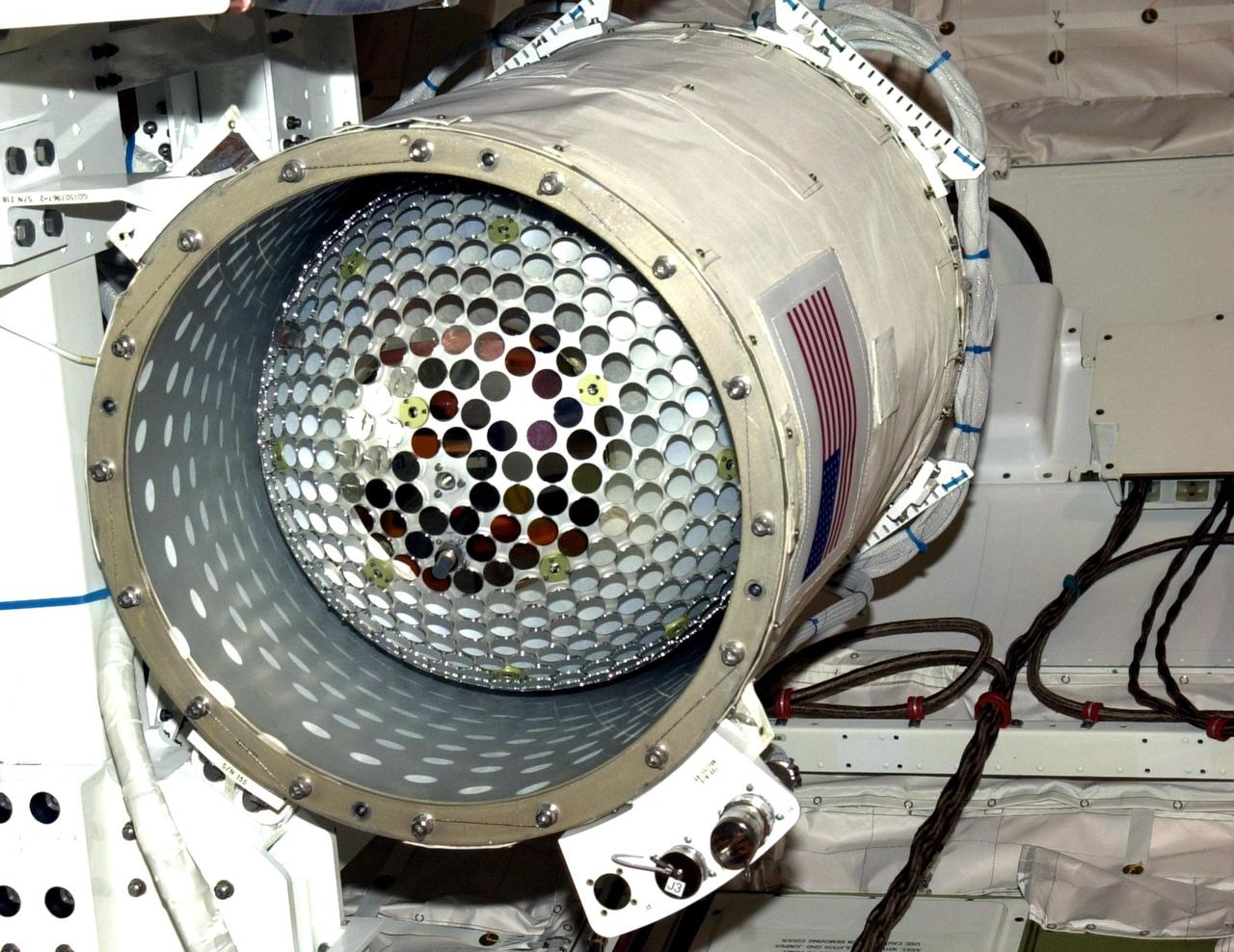 KENNEDY SPACE CENTER, Fla. --  A technician checks the mirrors on the Starshine-2 experiment inside a canister in the payload bay of Space Shuttle Endeavour.  The deployable experiment is being carried on mission STS-108.  Starshine-2's 800 aluminum mirrors were polished by more than 25,000 students from 26 countries. Top priorities for the STS-108 (UF-1) mission of Endeavour are rotation of the International Space Station Expedition Three and Expedition Four crews, bringing water, equipment and supplies to the station in the Multi-Purpose Logistics Module Raffaello, and completion of robotics tasks and a spacewalk to install thermal blankets over two pieces of equipment at the bases of the Space Station's solar wings. Liftoff of Endeavour on mission STS-108 is scheduled for 7:41 p.m. EST