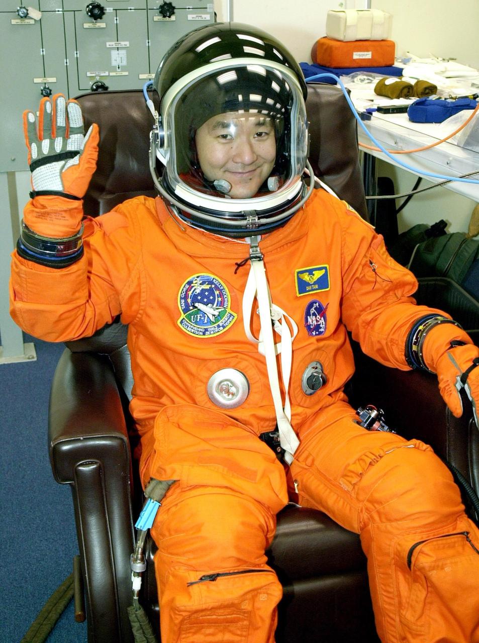 KENNEDY SPACE CENTER, Fla. -   STS-108 Mission Specialist Daniel M. Tani waves as he undergoes final suit check before launch on Nov. 29. Top priorities for the STS-108 (UF-1) mission of Endeavour are rotation of the International Space Station Expedition Three and Expedition Four crews; bringing water, equipment and supplies to the station in the Multi-Purpose Logistics Module Raffaello; and completion of robotics tasks and a spacewalk to install thermal blankets over two pieces of equipment at the bases of the Space Station's solar wings.  Liftoff is scheduled for 7:41 p.m. EST