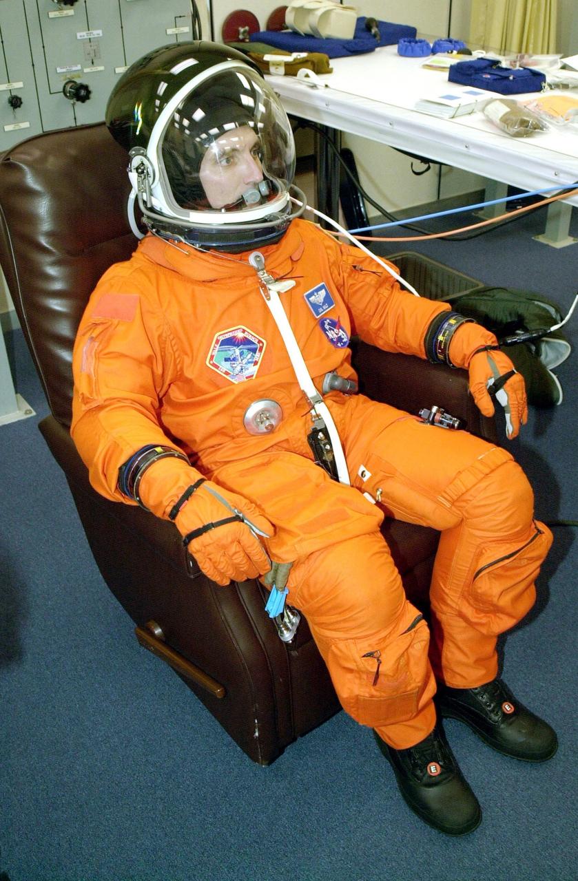 KENNEDY SPACE CENTER, Fla. --  Expedition 4 crew member Carl E. Walz undergoes final suit check before launch on mission STS-108 Nov. 29. Top priorities for the STS-108 (UF-1) mission of Endeavour are rotation of the International Space Station Expedition Three and Expedition Four crews; bringing water, equipment and supplies to the station in the Multi-Purpose Logistics Module Raffaello; and completion of robotics tasks and a spacewalk to install thermal blankets over two pieces of equipment at the bases of the Space Station's solar wings.  Liftoff is scheduled for 7:41 p.m. EST