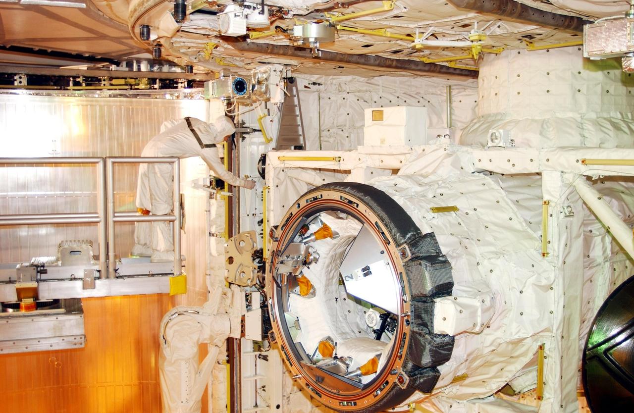 KENNEDY SPACE CENTER, Fla. - A technician prepares for payload bay closure on Space Shuttle Endeavour. Inside the bay is the Multi-Purpose Logistics Module Raffaello (foreground), carrying supplies, equipment and experiments for the International Space Station. Sharing the payload bay are several carriers with varying experiment packages, such as Starshine-2, a Get-Away Special. Endeavour is scheduled to launch Nov. 29 on this first Utilization Flight, STS-108, to the International Space Station. Endeavour will also carry the replacement Expedition 4 crew to the Station and return to Earth with the Expedition 3 crew