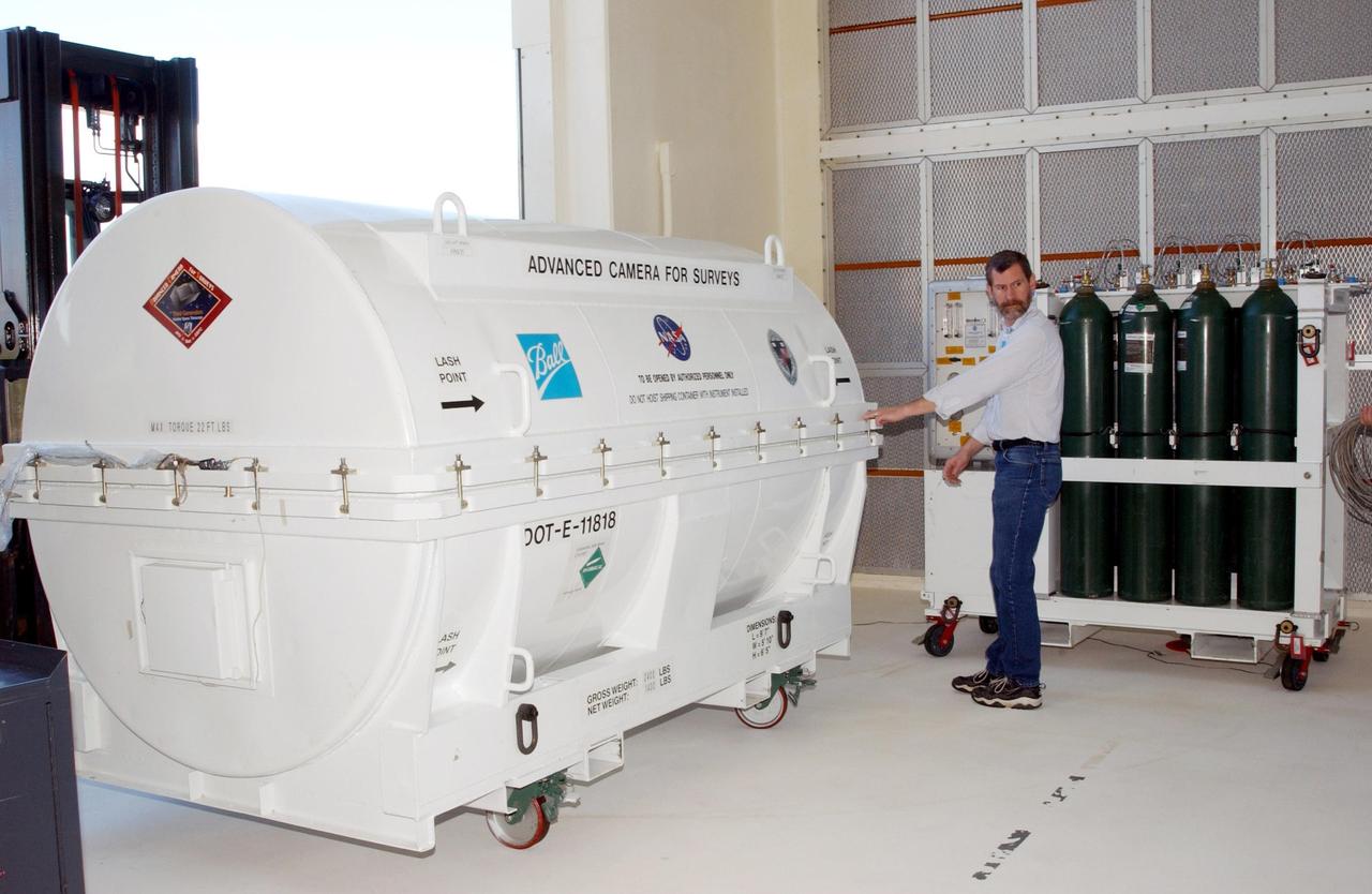 KENNEDY SPACE CENTER, Fla. -- A piece of equipment for Hubble Space Telescope Servicing mission is moved inside Hangar AE, Cape Canaveral.  In the canister is the Advanced Camera for Surveys (ACS). The ACS will increase the discovery efficiency of the HST by a factor of ten. It consists of three electronic cameras and a complement of filters and dispersers that detect light from the ultraviolet to the near infrared (1200 - 10,000 angstroms).  The ACS was built through a collaborative effort between Johns Hopkins University, Goddard Space Flight Center, Ball Aerospace Corporation and Space Telescope Science Institute. The goal of the mission, STS-109,  is to service the HST, replacing Solar Array 2 with Solar Array 3, replacing the Power Control Unit, removing the Faint Object Camera and installing the ACS, installing the Near Infrared Camera and Multi-Object Spectrometer (NICMOS) Cooling System, and installing New Outer Blanket Layer insulation on bays 5 through 8.  Mission STS-109 is scheduled for launch Feb. 14, 2002