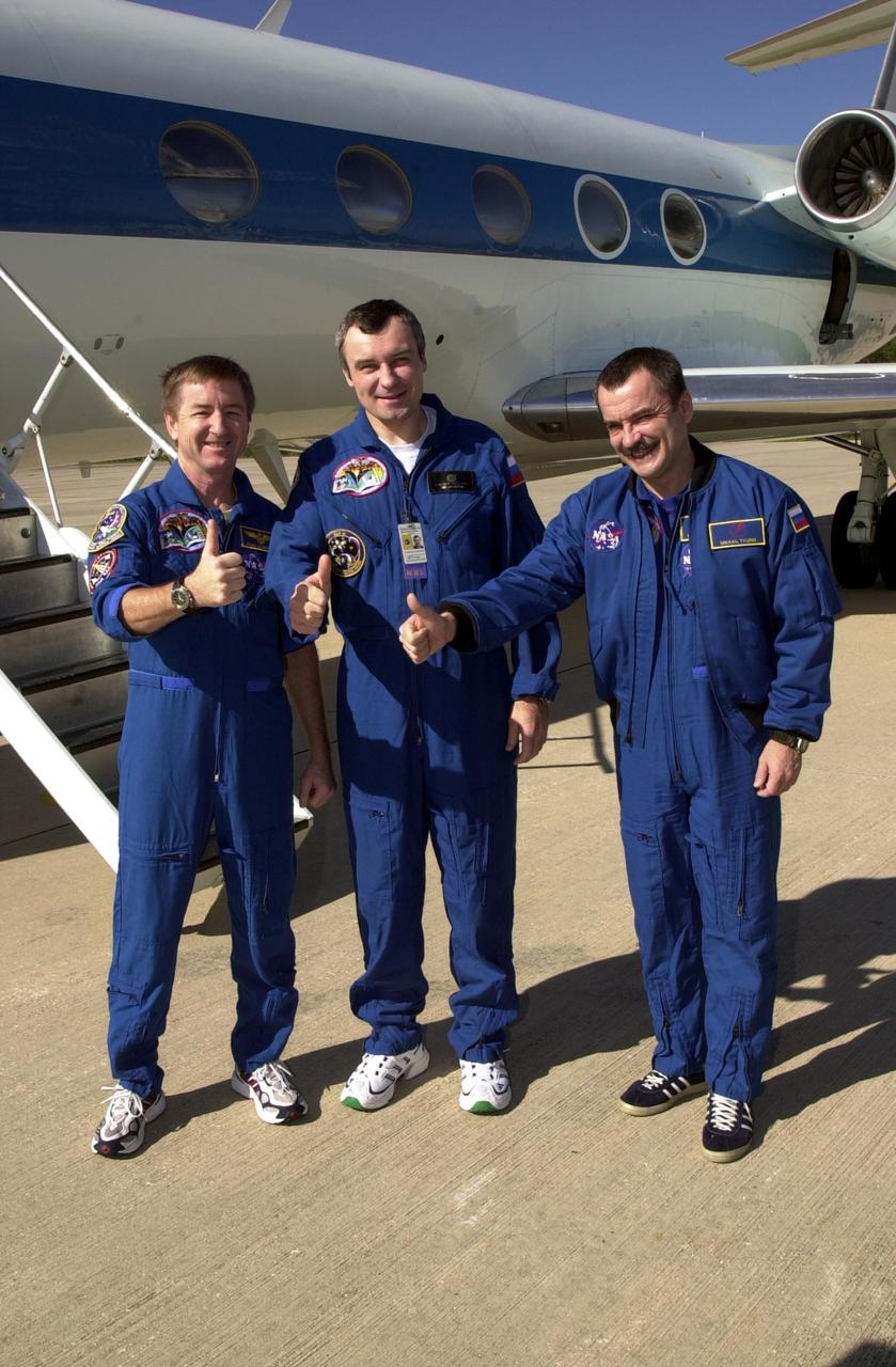 KENNEDY SPACE CENTER, FLA. --  The Expedition 3 crew show thumbs up on the verge of their departure from KSC to Houston. From left to right are Commander Frank Culbertson and cosmonauts Vladimir Dezhurov and Mikhail Tyurin.  The three returned to Earth as passengers aboard the orbiter Endeavour, which landed at KSC at 12:55 p.m. EST (17:55 GMT) Dec. 17, 2001, after completing mission STS-108.  Expedition 3 had spent 129 days on the International Space Station.  The landing is the 57th at KSC in the history of the program   STS-108 was the 12th mission to the Space Station.  This mission was the 107th flight in the Shuttle program and the 17th flight for the orbiter