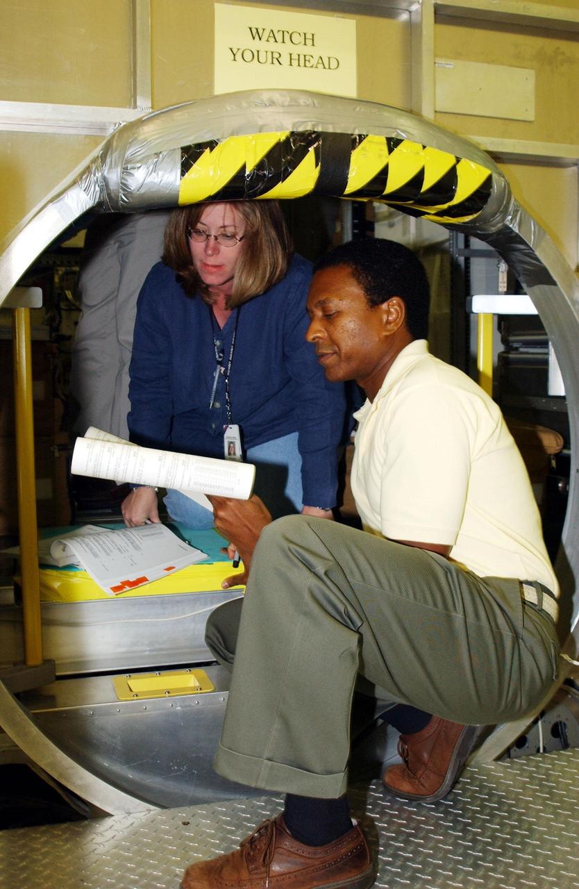 KENNEDY SPACE CENTER, FLA. - Inside the SPACEHAB module at SPACEHAB, Cape Canaveral, Fla.,  Payload Commander Michael Anderson scans documents. STS-107 is a research mission, and the primary payload is the first flight of the SHI Research Double Module (SHI/RDM). The experiments range from material sciences to life sciences (many rats).  Among the experiments is a Hitchhiker carrier system, modular and expandable in accordance with payload requirements.  STS-107 is scheduled to launch in June 2002.