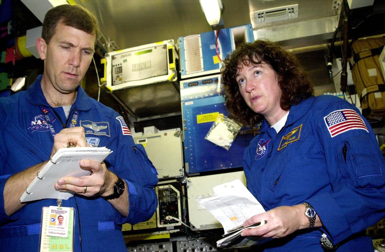 KENNEDY SPACE CENTER, FLA. -- STS-107 Commander Rick Husband and Mission Specialist Laurel Clark learn to work with mission-related equipment at SPACEHAB, Cape Canaveral, Fla. STS-107 is a research mission. The primary payload is the first flight of the SHI Research Double Module (SHI/RDM). The experiments range from material sciences to life sciences (many rats). Also part of the payload is the Fast Reaction Experiments Enabling Science, Technology, Applications and Research (FREESTAR) that incorporates eight high priority secondary attached shuttle experiments: Mediterranean Israeli Dust Experiment (MEIDEX), Shuttle Ozone Limb Sounding Experiment (SOLSE-2), Student Tracked Atmospheric Research Satellite for Heuristic International Networking Experiment (STARSHINE), Critical Viscosity of Xenon-2 (CVX-2), Solar Constant Experiment-3 (SOLOCON-3), Prototype Synchrotron Radiation Detector (PSRD), Low Power Transceiver (LPT), and Collisions Into Dust Experiment -2 (COLLIDE-2). STS-107 is scheduled to launch in July 2002