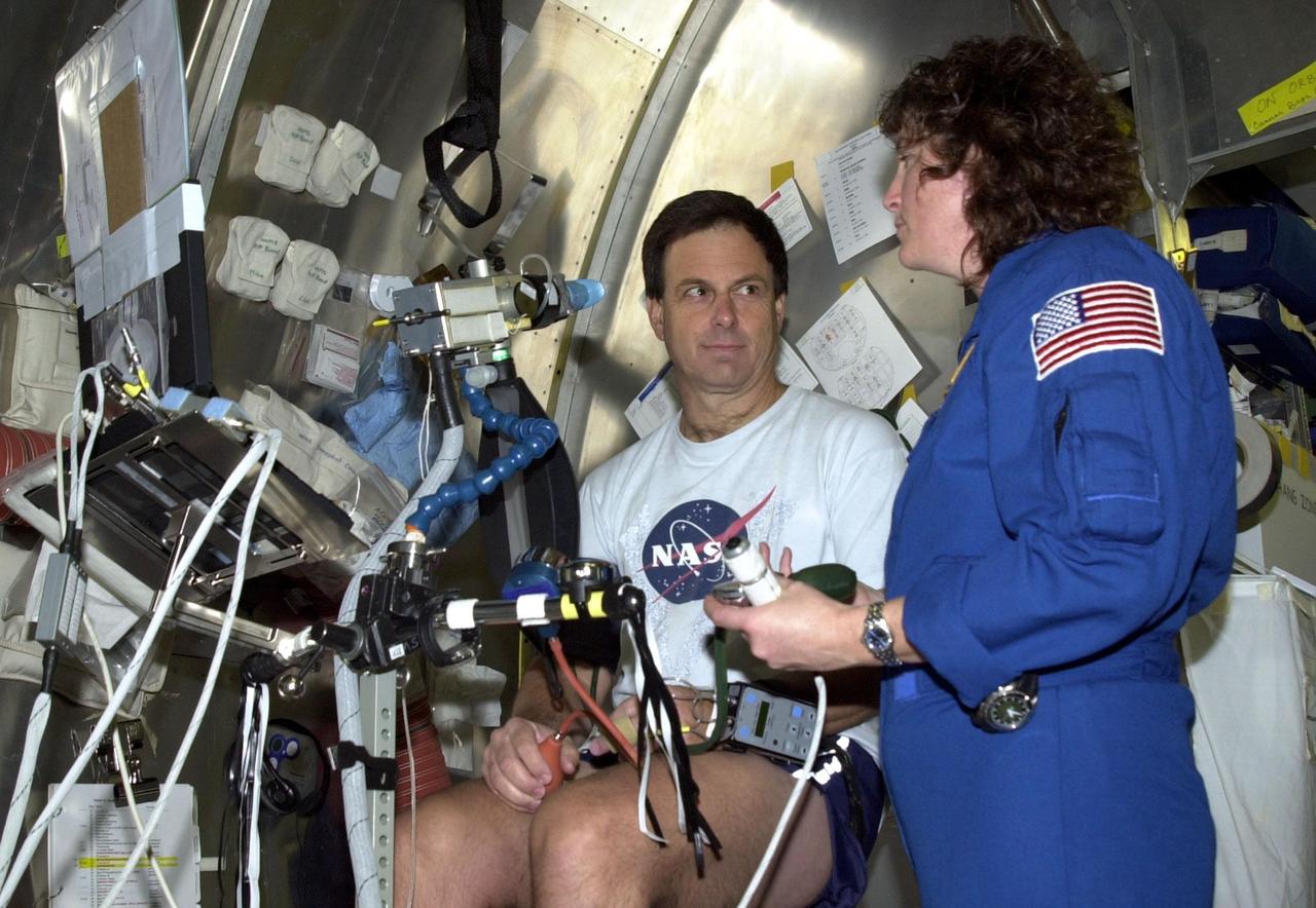 KENNEDY SPACE CENTER, FLA. - STS-107 Payload Specialist Ilan Ramon, from Israel, pauses during an experiment at SPACEHAB, Cape Canaveral, Fla., to talk with Mission Specialist Laurel Clark. STS-107 is a research mission. The primary payload is the first flight of the SHI Research Double Module (SHI/RDM). The experiments range from material sciences to life sciences (many rats). Also part of the payload is the Fast Reaction Experiments Enabling Science, Technology, Applications and Research (FREESTAR) that incorporates eight high priority secondary attached shuttle experiments: Mediterranean Israeli Dust Experiment (MEIDEX), Shuttle Ozone Limb Sounding Experiment (SOLSE-2), Student Tracked Atmospheric Research Satellite for Heuristic International Networking Experiment (STARSHINE), Critical Viscosity of Xenon-2 (CVX-2), Solar Constant Experiment-3 (SOLOCON-3), Prototype Synchrotron Radiation Detector (PSRD), Low Power Transceiver (LPT), and Collisions Into Dust Experiment -2 (COLLIDE-2). STS-107 is scheduled to launch in July 2002.