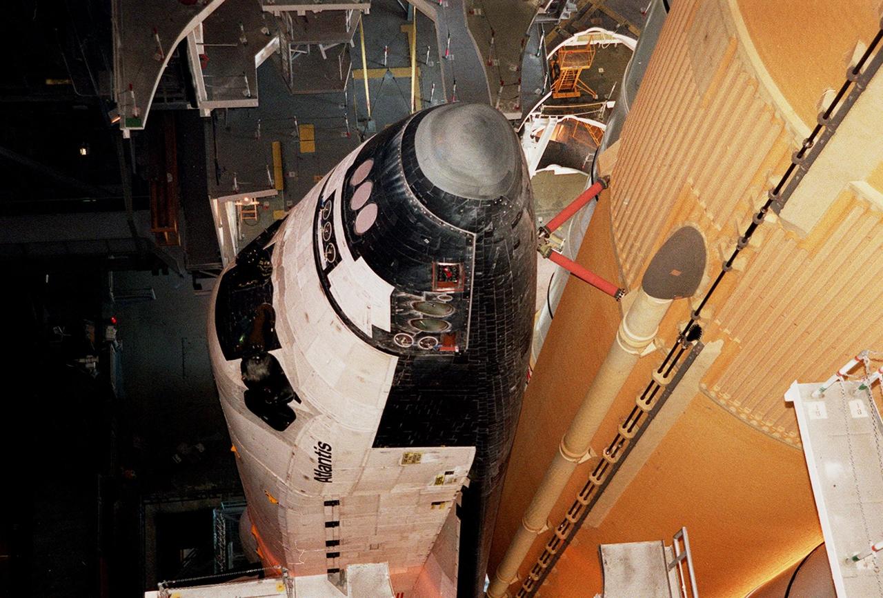 KENNEDY SPACE CENTER, Fla. -- The nose of Atlantis is seen in this closeup, along with the braces that attach it to the external tank at right. Space Shuttle Atlantis is making its second rollout attempt to Launch Pad 39A. An attempt to roll out on Jan. 2 incurred a failed computer processor on the crawler transporter and the Shuttle was returned to the Vehicle Assembly Building using a secondary computer processor on the vehicle. Atlantis will fly on mission STS-98, the seventh construction flight to the International Space Station, carrying the U.S. Laboratory, named Destiny. The lab will have five system racks already installed inside the module. After delivery of electronics in the lab, electrically powered attitude control for Control Moment Gyroscopes will be activated. Atlantis is scheduled for launch no earlier than Jan. 19, 2001, with a crew of five