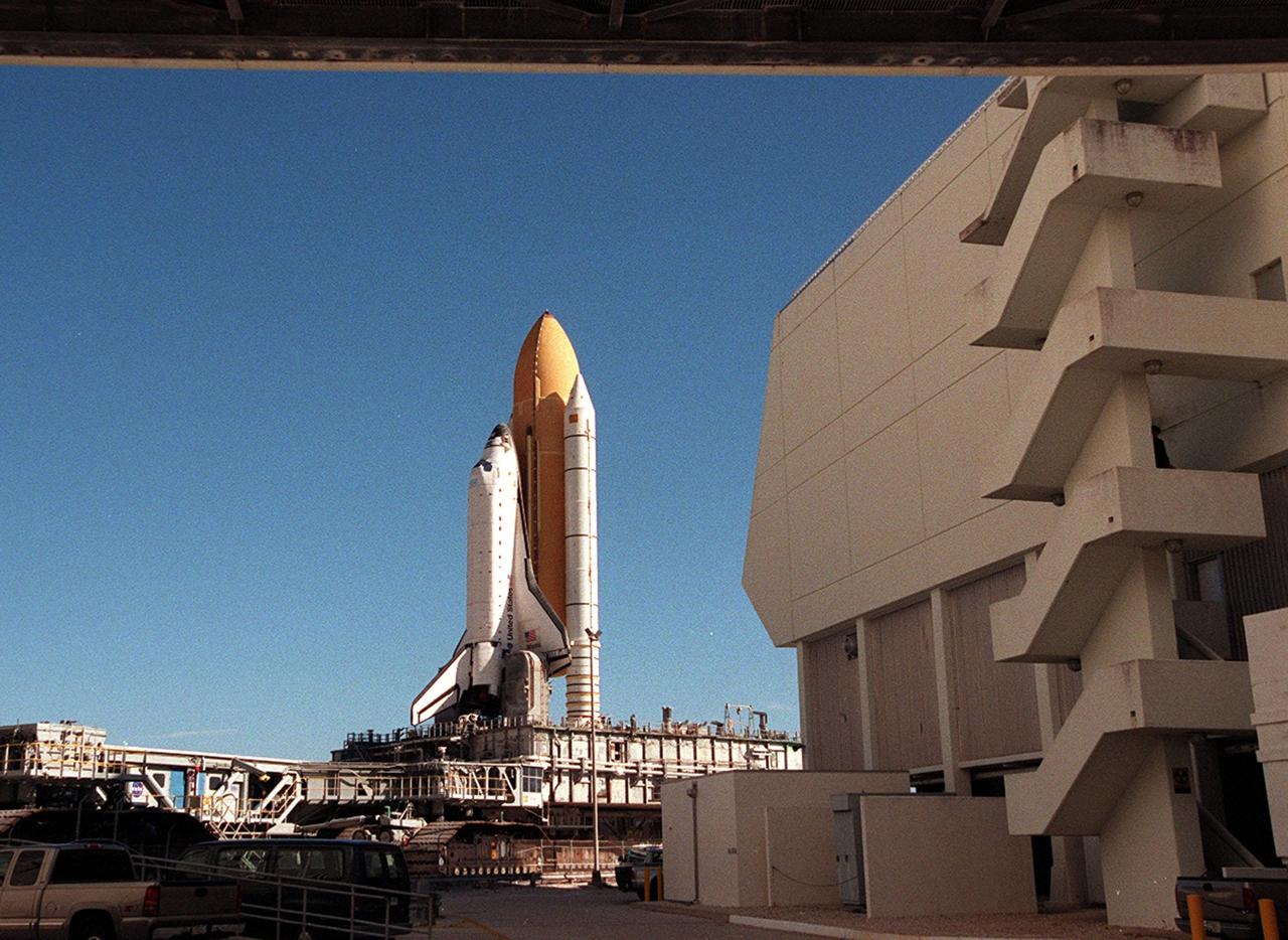 KENNEDY SPACE CENTER, Fla. -- As Space Shuttle Atlantis inches its way to Launch Pad 39A for the second time, it passes the Launch Control Center (right). An attempt to roll out on Jan. 2 incurred a failed computer processor on the crawler transporter and the Shuttle was returned to the Vehicle Assembly Building using a secondary computer processor on the vehicle. Atlantis will fly on mission STS-98, the seventh construction flight to the International Space Station, carrying the U.S. Laboratory, named Destiny. The lab will have five system racks already installed inside the module. After delivery of electronics in the lab, electrically powered attitude control for Control Moment Gyroscopes will be activated. Atlantis is scheduled for launch no earlier than Jan. 19, 2001, with a crew of five