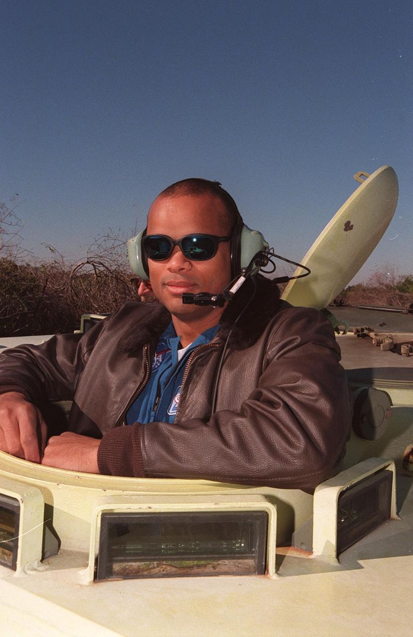 Robert Curbeam, a Mission Specialist on STS-98, gets ready to take the driver’s seat in an M-113 armored carrier, part of emergency egress training at Launch Pad 39A. In the event of an emergency at the pad prior to launch, the carrier could be used to transport the crew to a nearby bunker or farther,. The STS-98 crew is at KSC to take part in Terminal Countdown Demonstration Test activities, which also includes a simulated launch countdown. STS-98 is the seventh construction flight to the International Space Station, carrying as payload the U.S. Lab Destiny, a key element in the construction of the ISS