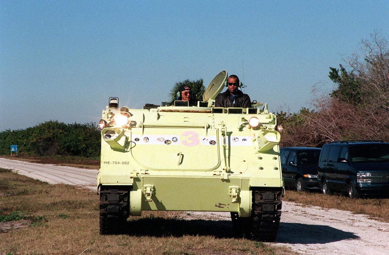 STS-98 Mission Specialist Robert Curbeam (right) takes a turn driving an M-113 armored carrier, part of emergency egress training at Launch Pad 39A. Seated alongside is Capt. George Hoggard (left), a training officer with SGS Fire Services. In the event of an emergency at the pad prior to launch, the carrier could be used to transport the crew to a nearby bunker or farther. The STS-98 crew is at KSC to take part in Terminal Countdown Demonstration Test activities, which also includes a simulated launch countdown. STS-98 is the seventh construction flight to the International Space Station, carrying as payload the U.S. Lab Destiny, a key element in the construction of the ISS