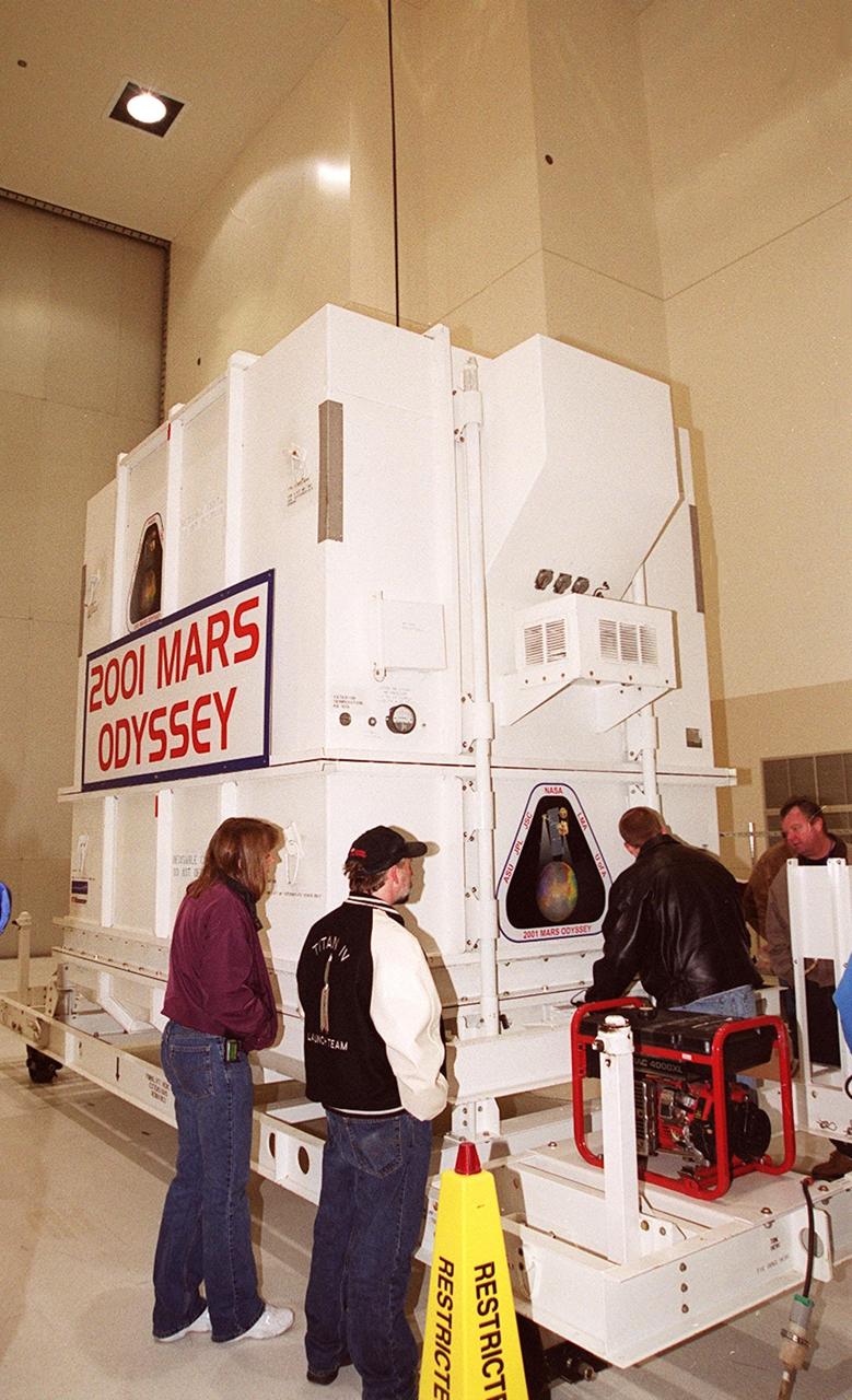The crated 2001 Mars Odyssey spacecraft rests safely inside the Spacecraft Assembly and Encapsulation Facility 2 (SAEF-2) located in the KSC Industrial Area. The spacecraft arrived at KSC’s Shuttle Landing Facility aboard an Air Force C-17 cargo airplane that brought it from Denver, Colo.., location of the Lockheed Martin plant where the spacecraft was built. In the SAEF, Odyssey will undergo final assembly and checkout. This includes installation of two of the three science instruments, integration of the three-panel solar array, and a spacecraft functional test. It will be fueled and then mated to an upper stage booster, the final activities before going to the launch pad. Launch is planned for April 7, 2001 the first day of a 21-day planetary window. Mars Odyssey will be inserted into an interplanetary trajectory by a Boeing Delta II launch vehicle from Pad A at Complex 17 at the Cape Canaveral Air Force Station, Fla. The spacecraft will arrive at Mars on Oct. 20, 2001, for insertion into an initial elliptical capture orbit. Its final operational altitude will be a 250-mile-high, Sun-synchronous polar orbit. Mars Odyssey will spend two years mapping the planet's surface and measuring its environment
