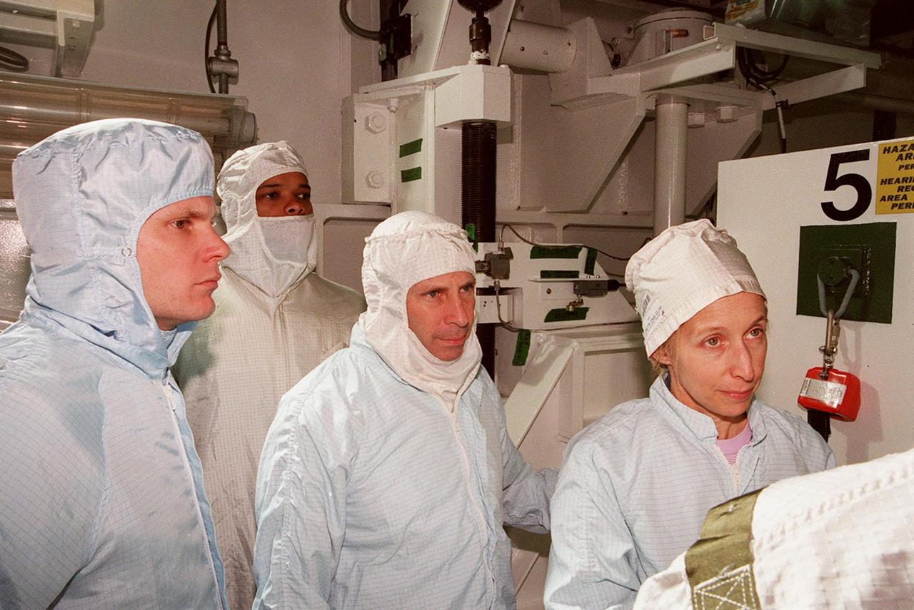 KENNEDY SPACE CENTER, FLA. -- Along with Scott Thurston (left), of the VITT office, members of the STS-98 crew Mission Specialist Robert Curbeam, Commander Ken Cockrell and Mission Specialist Marsha Ivins are in Atlantis’ payload bay to check out their mission payload, the U.S. Lab Destiny. The crew is at KSC for Terminal Countdown Demonstration Test activities, which also include a simulated launch countdown. A key element in the construction of the International Space Station, Destiny is a pressurized module designed to accommodate pressurized payloads. It has a capacity of 24 rack locations. Payload racks will occupy 13 locations especially designed to support experiments. The module already has five system racks installed inside. Launch of STS-98 on its 11-day mission is scheduled for Jan. 19 at 2:11 a.m. EST