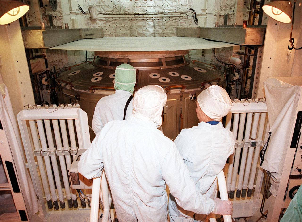 KENNEDY SPACE CENTER, FLA. -- In the payload bay of the orbiter Atlantis, STS-98 Commander Ken Cockrell (center) and Mission Specialist Marsha Ivins (right) look over the mission payload, the U.S. Lab Destiny (in the background). The crew is at KSC for Terminal Countdown Demonstration Test activities, which also include a simulated launch countdown. A key element in the construction of the International Space Station, Destiny is a pressurized module designed to accommodate pressurized payloads. It has a capacity of 24 rack locations. Payload racks will occupy 13 locations especially designed to support experiments. The module already has five system racks installed inside. Launch of STS-98 on its 11-day mission is scheduled for Jan. 19 at 2:11 a.m. EST