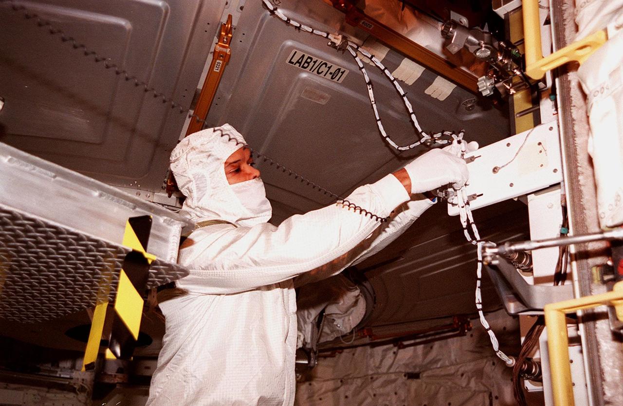 KENNEDY SPACE CENTER, FLA. -- In the payload bay of the orbiter Atlantis, STS-98 Mission Specialist Robert Curbeam works with equipment he will use in space to attach the U.S. Lab Destiny to the International Space Station. The crew is at KSC for Terminal Countdown Demonstration Test activities, which also include a simulated launch countdown. A key element in the construction of the International Space Station, Destiny is a pressurized module designed to accommodate pressurized payloads. It has a capacity of 24 rack locations. Payload racks will occupy 13 locations especially designed to support experiments. The module already has five system racks installed inside. Launch of STS-98 on its 11-day mission is scheduled for Jan. 19 at 2:11 a.m. EST